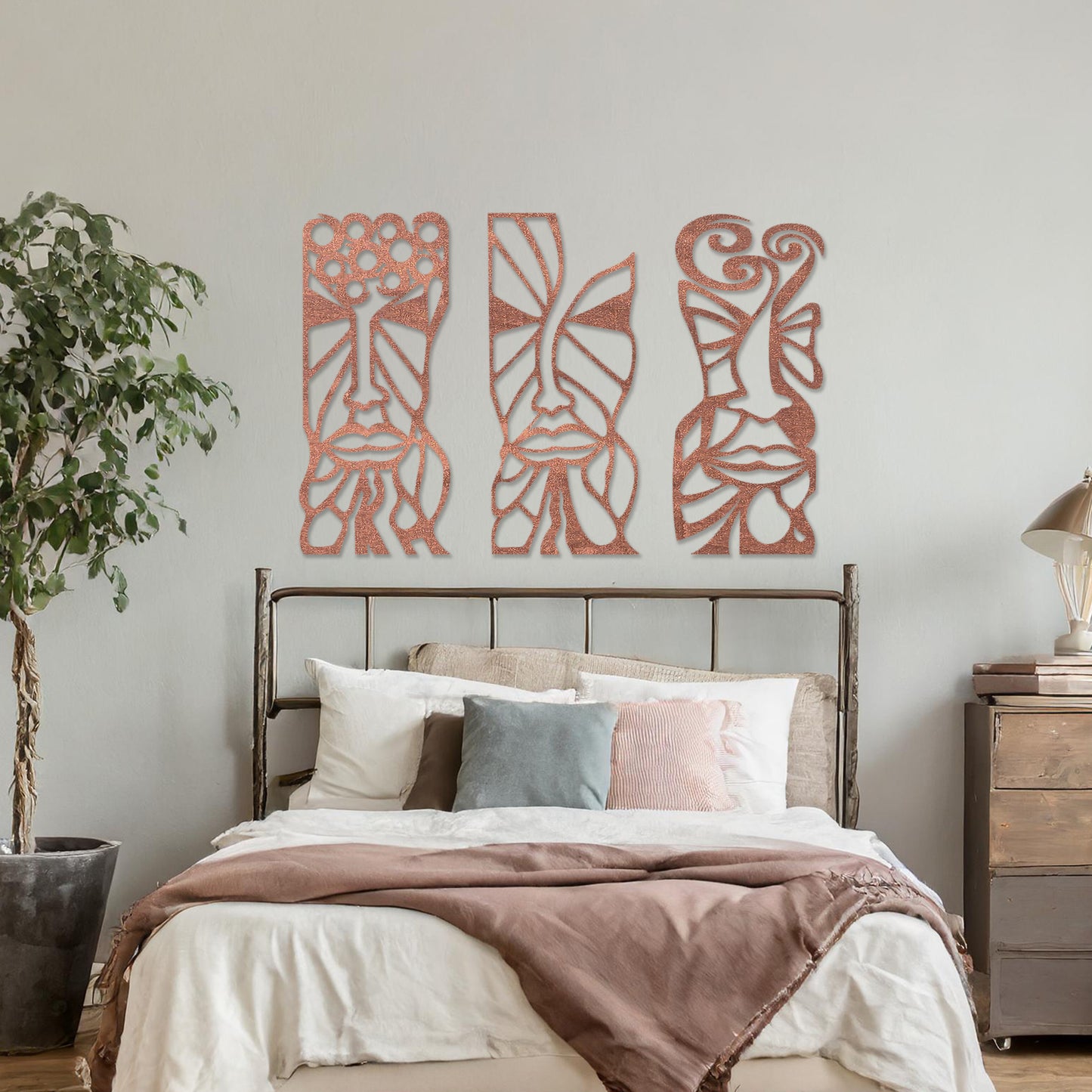 Wooden wall art set featuring three abstract face designs with intricate geometric and flowing patterns, displayed on a neutral wall within modern room decor, highlighting their artistic and contemporary appeal.