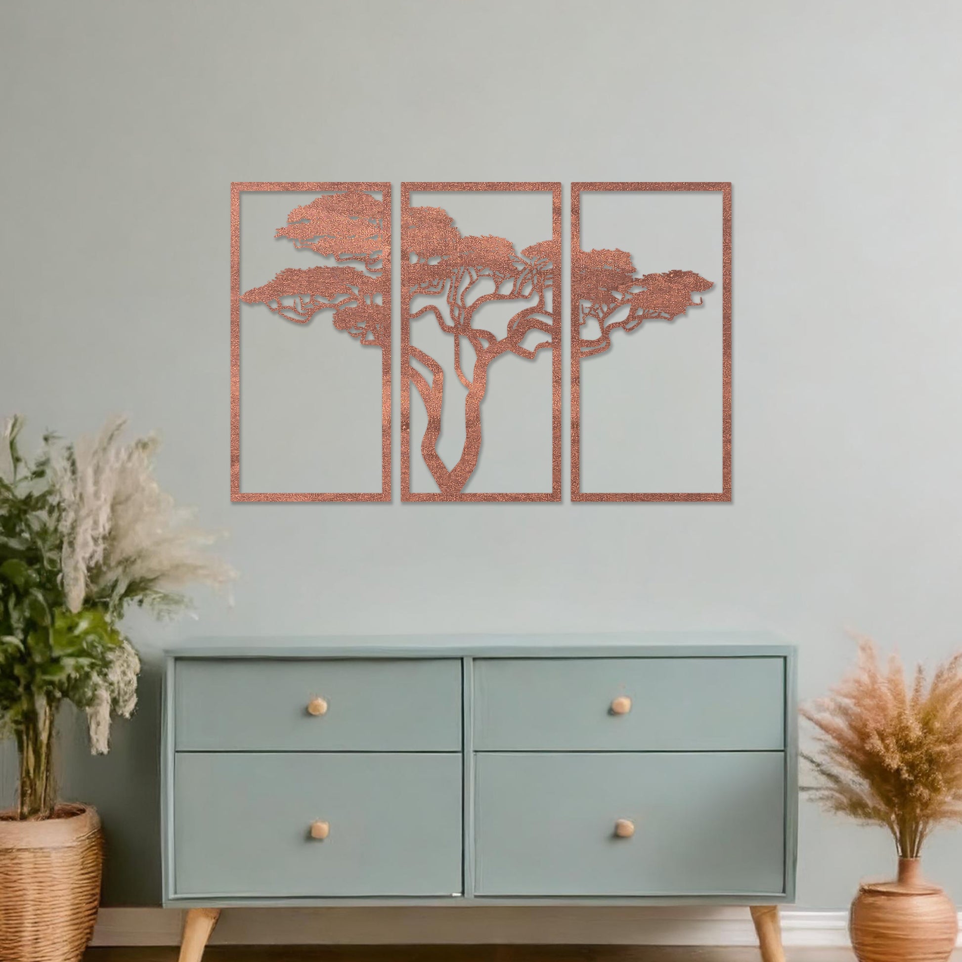 Three-panel wooden wall art featuring an elegant silhouette of a tree with spreading branches, displayed on a neutral wall within modern room decor. The intricate design adds depth and sophistication to the space.