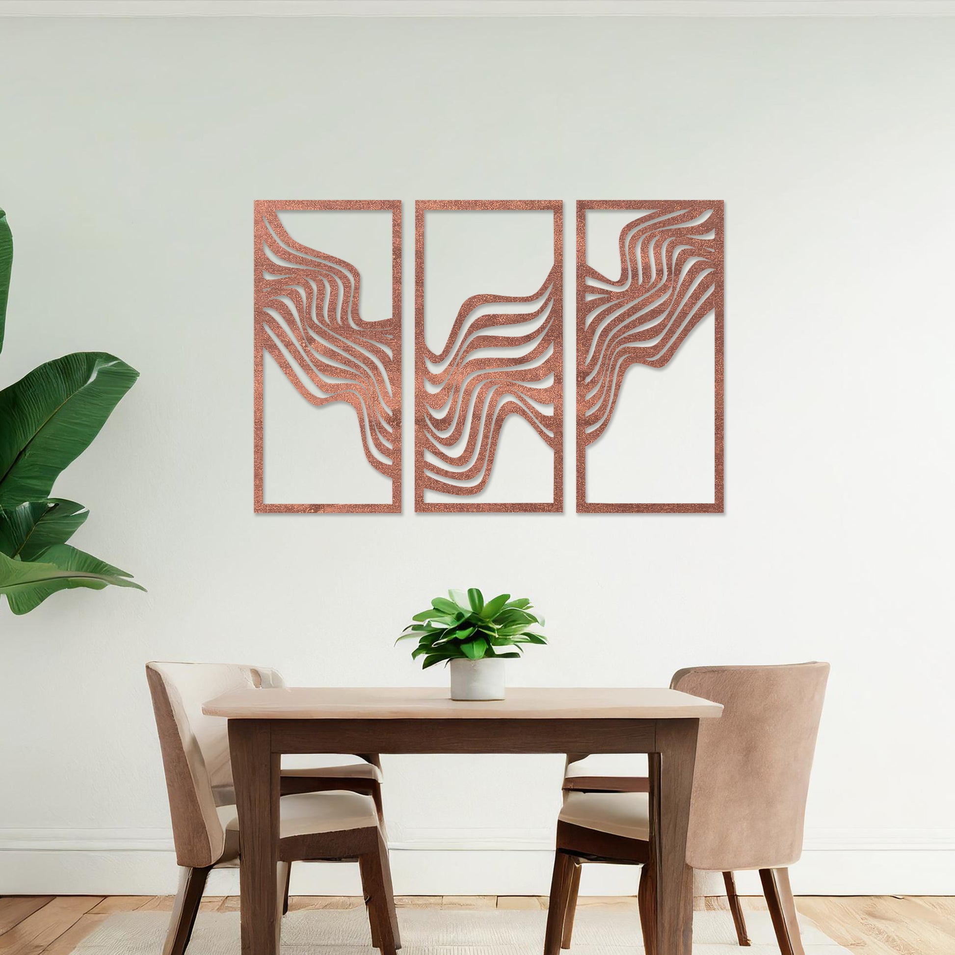 This image displays a modern triptych wall art design featuring flowing wave-like lines. The abstract patterns create a dynamic and visually appealing composition, adding an elegant touch to the living room's decor, complemented by a colourful sofa and floor lighting.