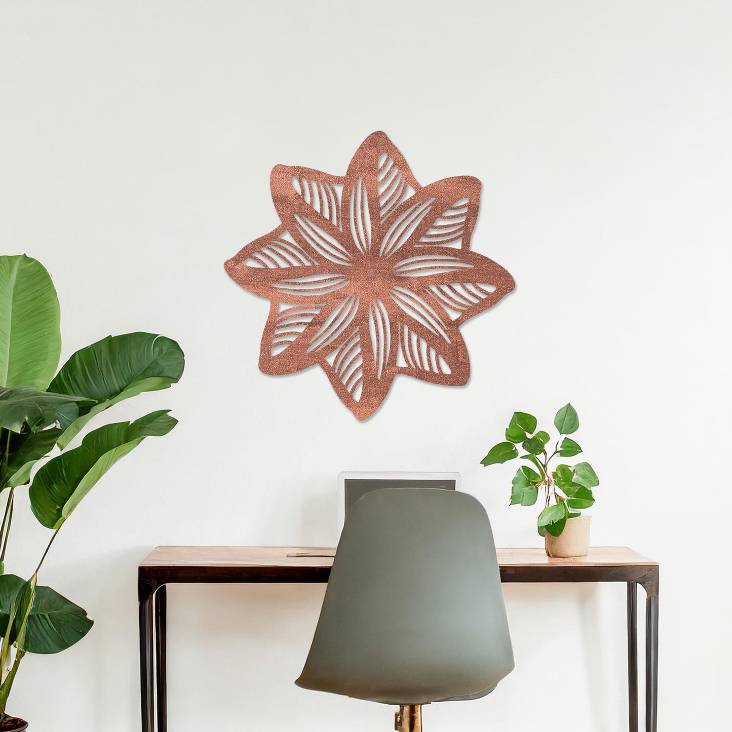 Wall art featuring a star-shaped floral design with layered petals and intricate cut-out patterns. The piece is displayed on a neutral wall within modern decor, adding a unique and decorative focal point to the space.