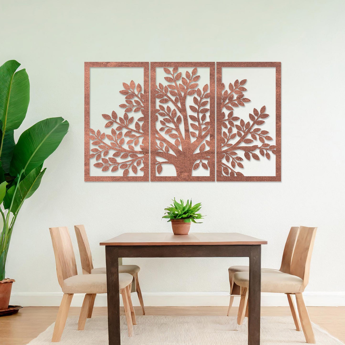 Wooden wall art comprising three panels featuring a tree design with detailed leaves and branches, displayed on a neutral wall within modern room decor, showcasing its intricate and natural craftsmanship.