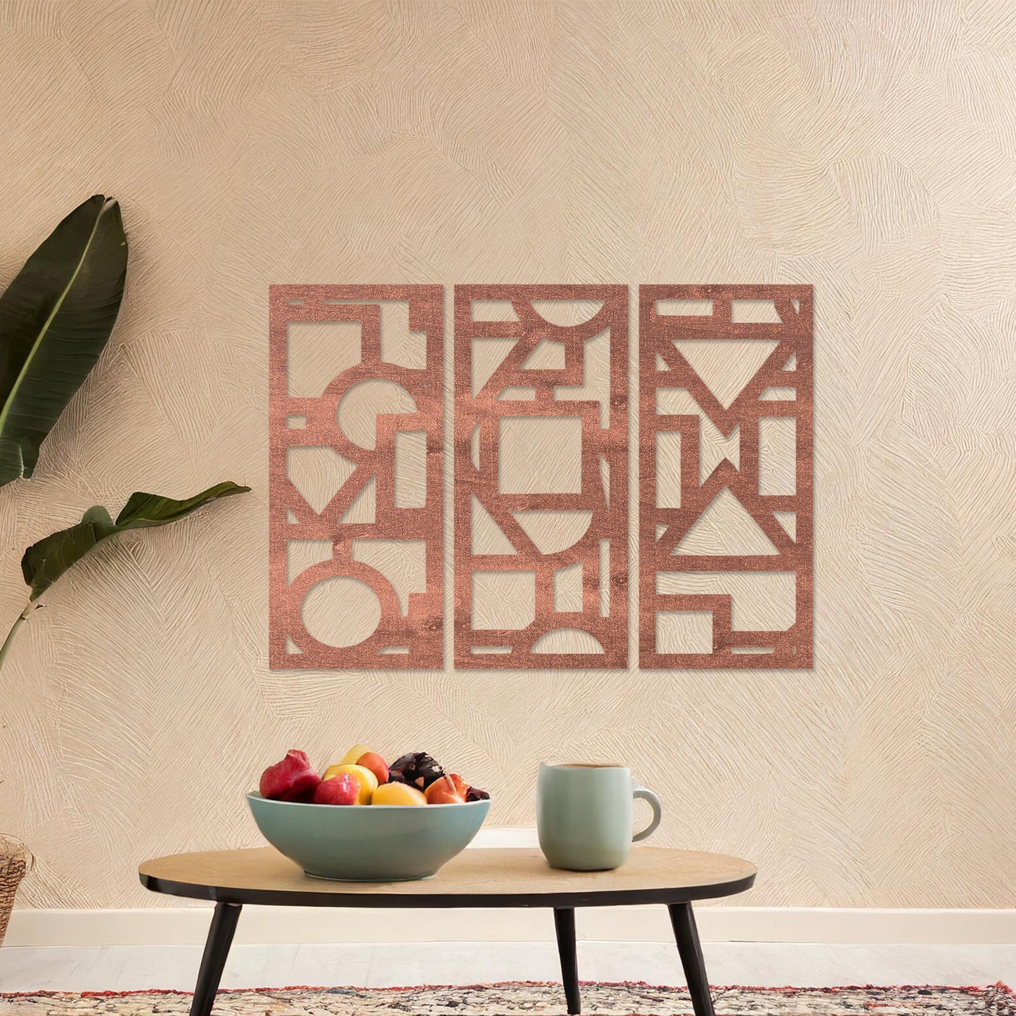 This image features a vibrant, modern triptych wall art design made of geometric shapes and patterns. The bold black designs contrast against a light green wall, complementing the stylish sofa below.