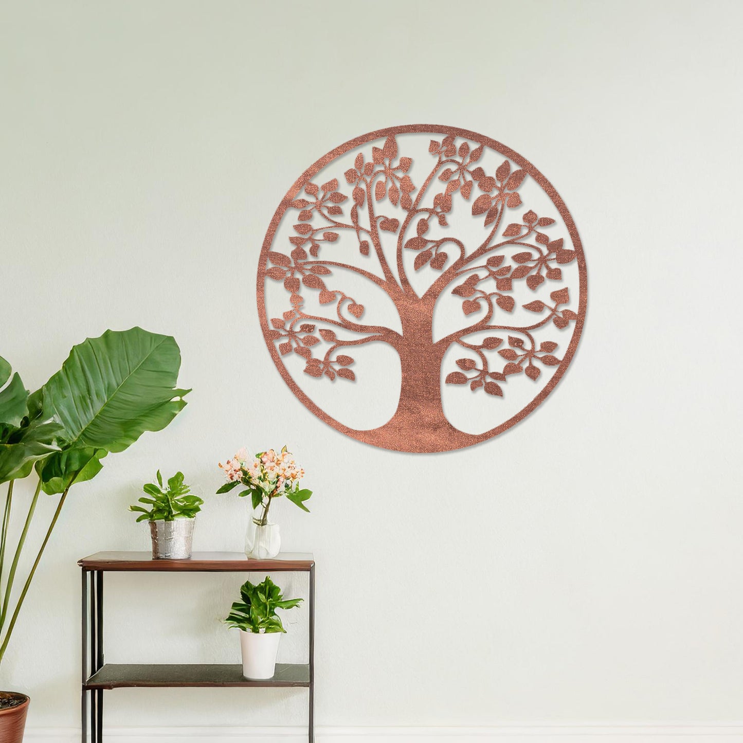 Wooden wall art featuring a circular tree design with detailed leaves and branches, displayed on a neutral wall within modern room decor, emphasising its natural elegance and intricate craftsmanship.