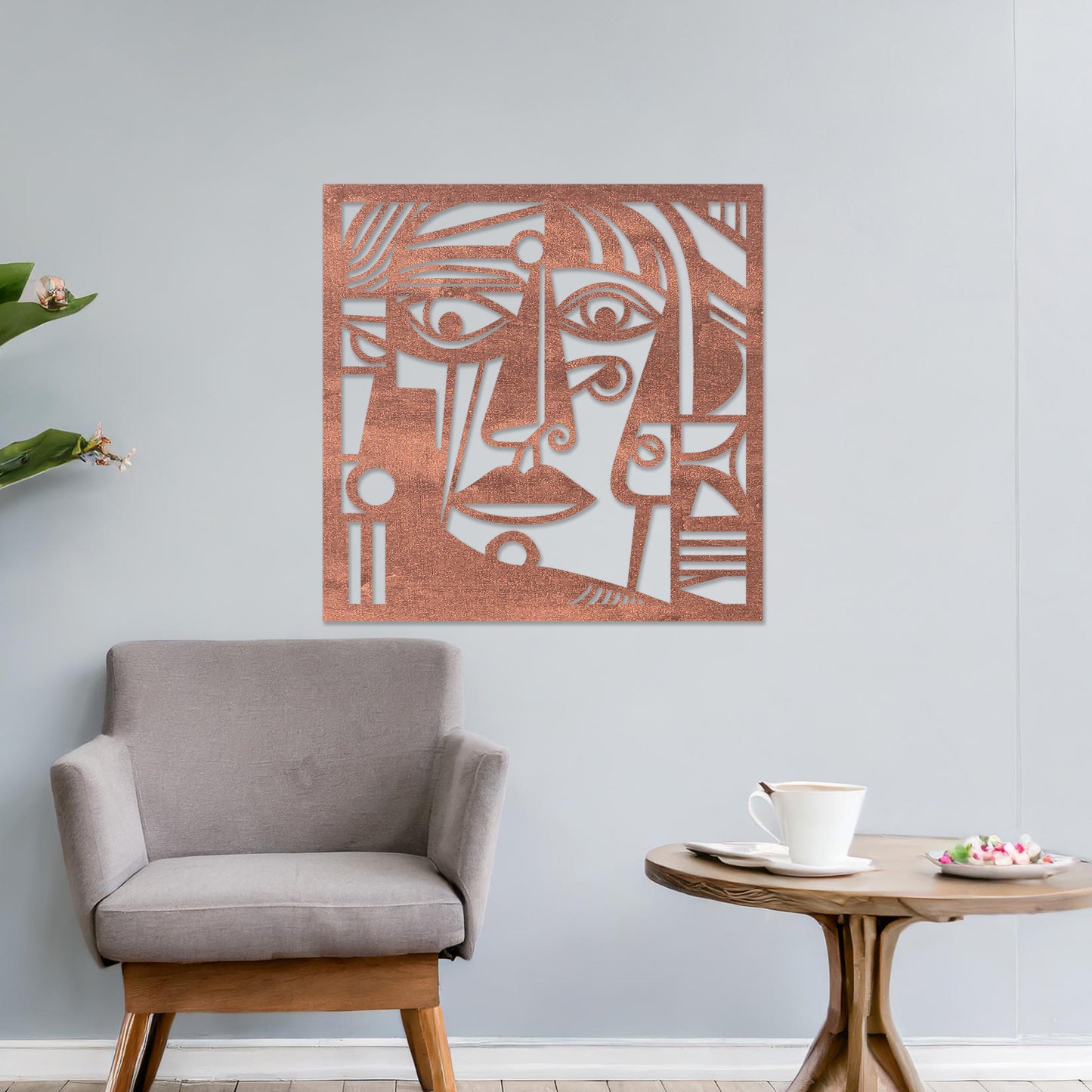 Wall art featuring an abstract face design with bold geometric shapes and intricate linework. The piece is displayed on a neutral wall within modern decor, adding an artistic and expressive focal point to the space.