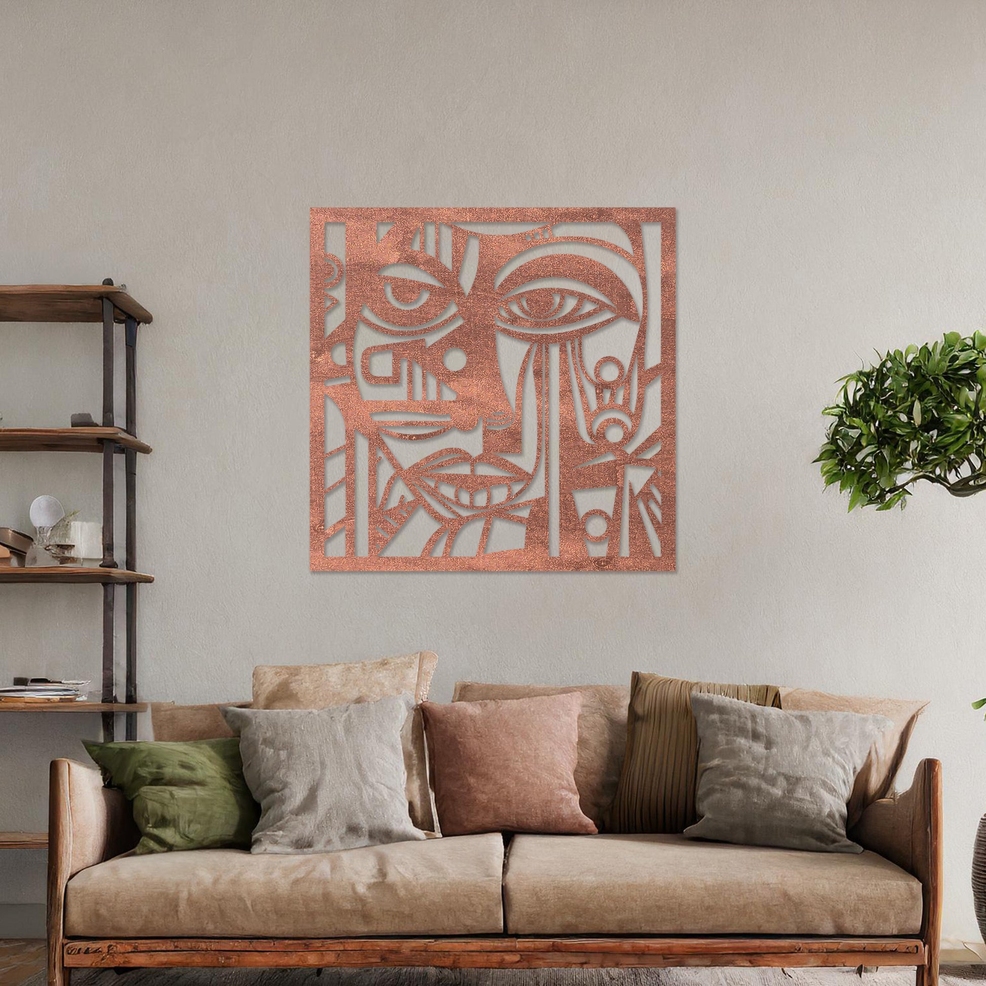 Wall art featuring an abstract face design with geometric patterns and intricate details, creating a modern and artistic composition. The piece is displayed on a neutral wall within rustic-modern decor, adding a bold and expressive focal point to the space.