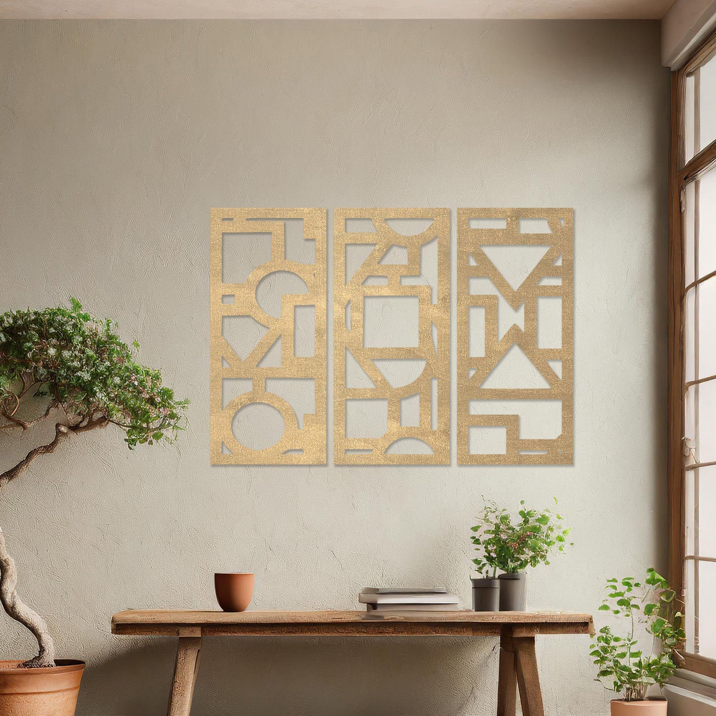 This image features a vibrant, modern triptych wall art design made of geometric shapes and patterns. The bold black designs contrast against a light green wall, complementing the stylish sofa below.