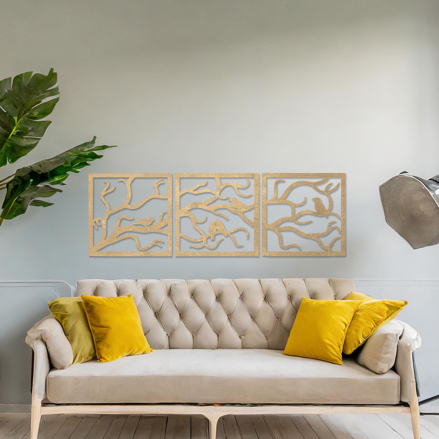 A three-panel wall art showcasing a design of birds perched on delicate tree branches. The intricate artwork is displayed on a neutral wall in a modern room, enhancing the natural and elegant ambiance of the decor.