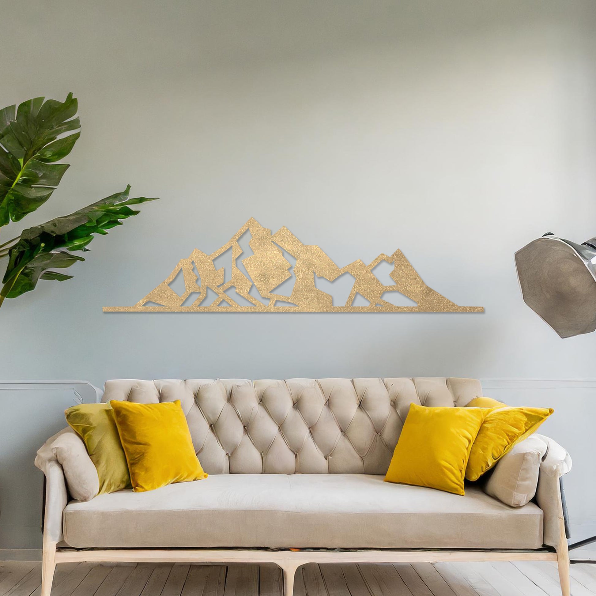 Wall art featuring a minimalist mountain range design with sharp geometric peaks. The piece is displayed on a neutral wall within modern decor, adding a natural and contemporary accent to the space.