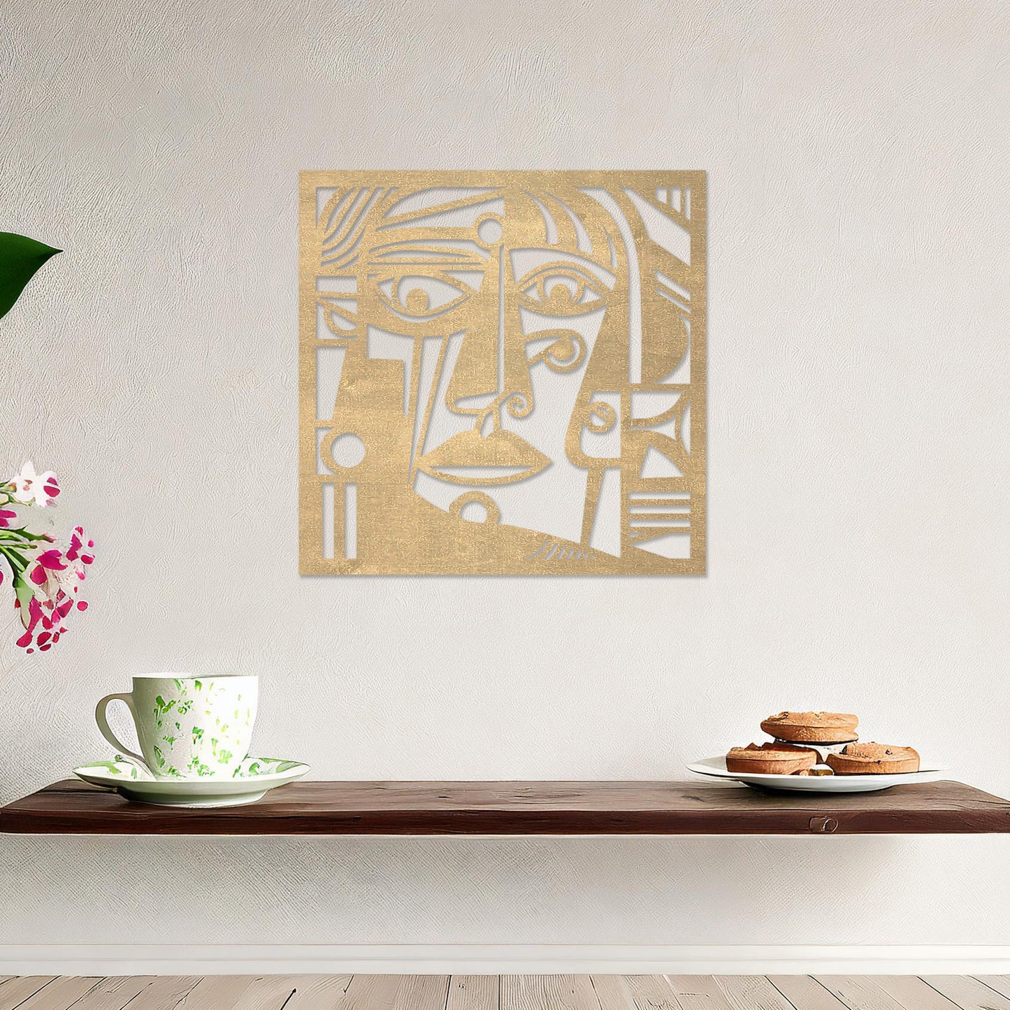 Wall art featuring an abstract face design with bold geometric shapes and intricate linework. The piece is displayed on a neutral wall within modern decor, adding an artistic and expressive focal point to the space.