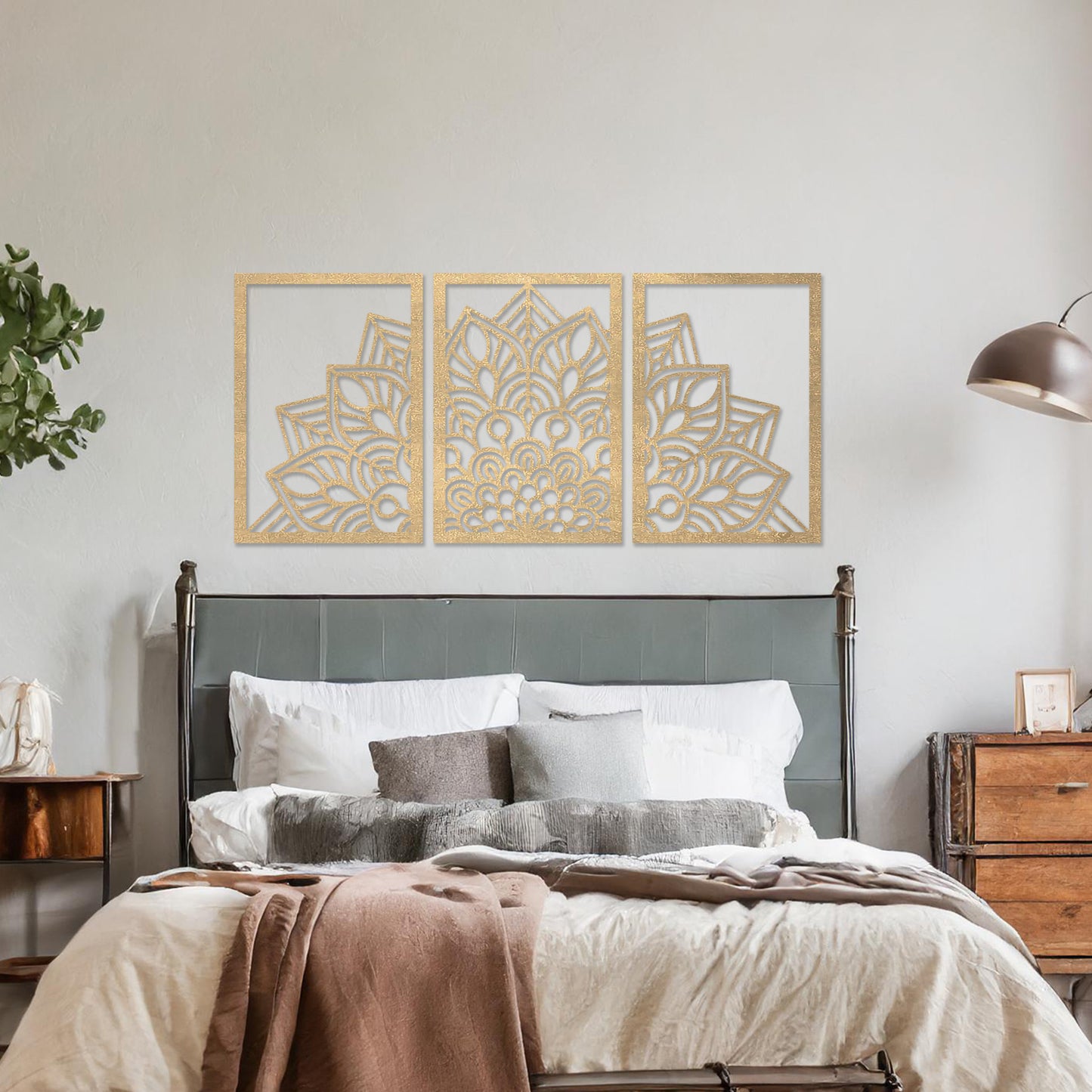 Wall art featuring a triptych design with an intricate mandala pattern spread across three panels. The artwork is displayed on a neutral wall within modern room decor, adding a harmonious and decorative touch to the setting.