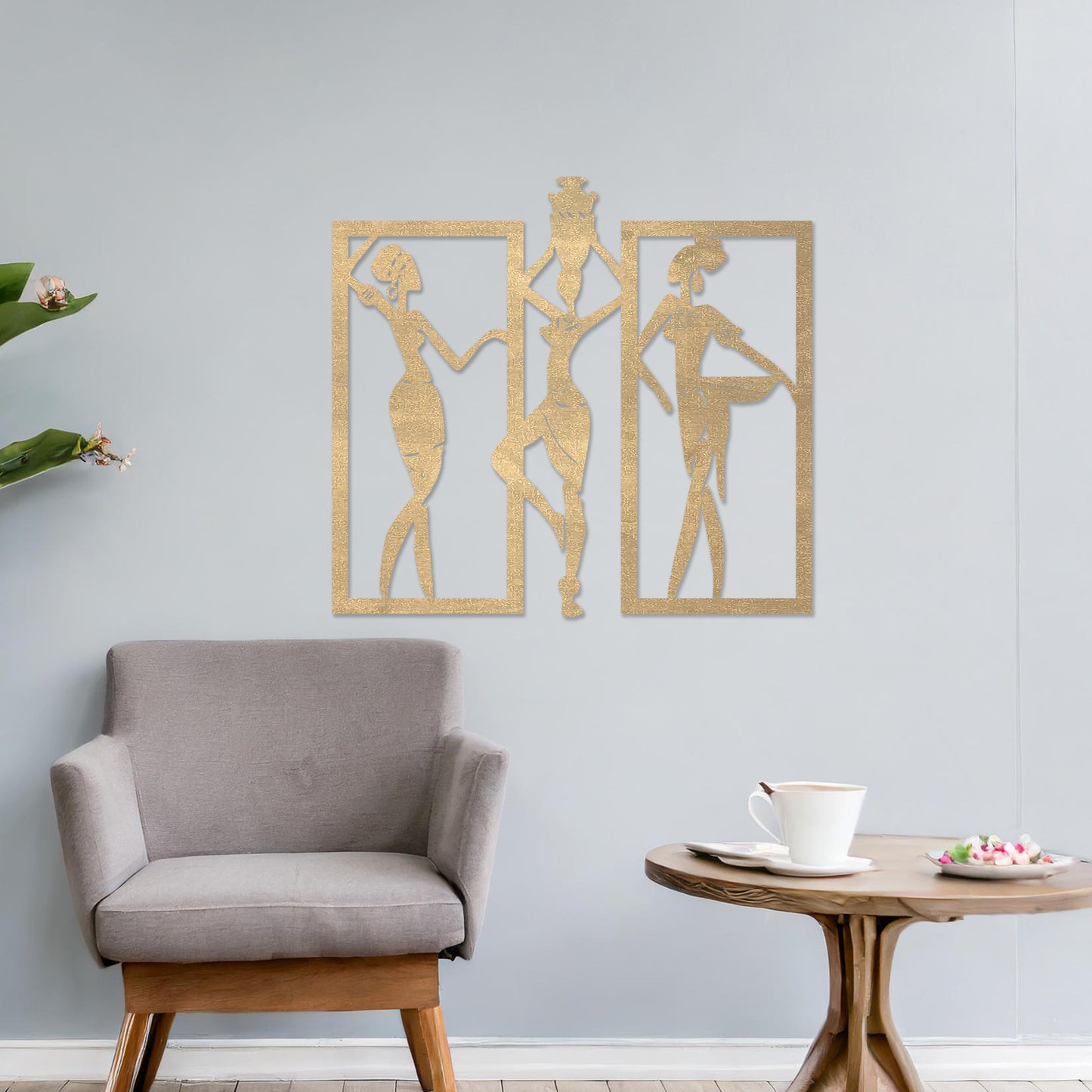 Wall art featuring a triptych design of abstract figures in dynamic poses, framed within rectangular panels. The artwork is displayed on a neutral wall within modern decor, adding an artistic and cultural touch to the space.