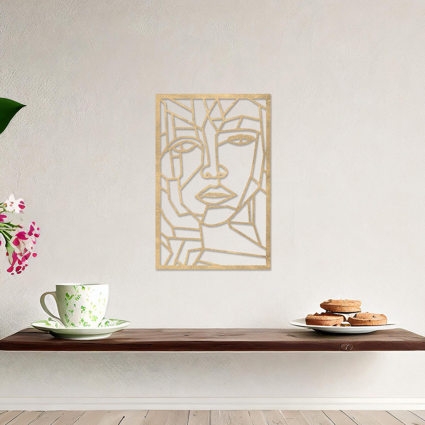 Wall art featuring a geometric abstract face design with sharp angular lines forming a modern and artistic composition. The piece is displayed on a neutral wall within contemporary decor, adding a bold and creative focal point to the space.