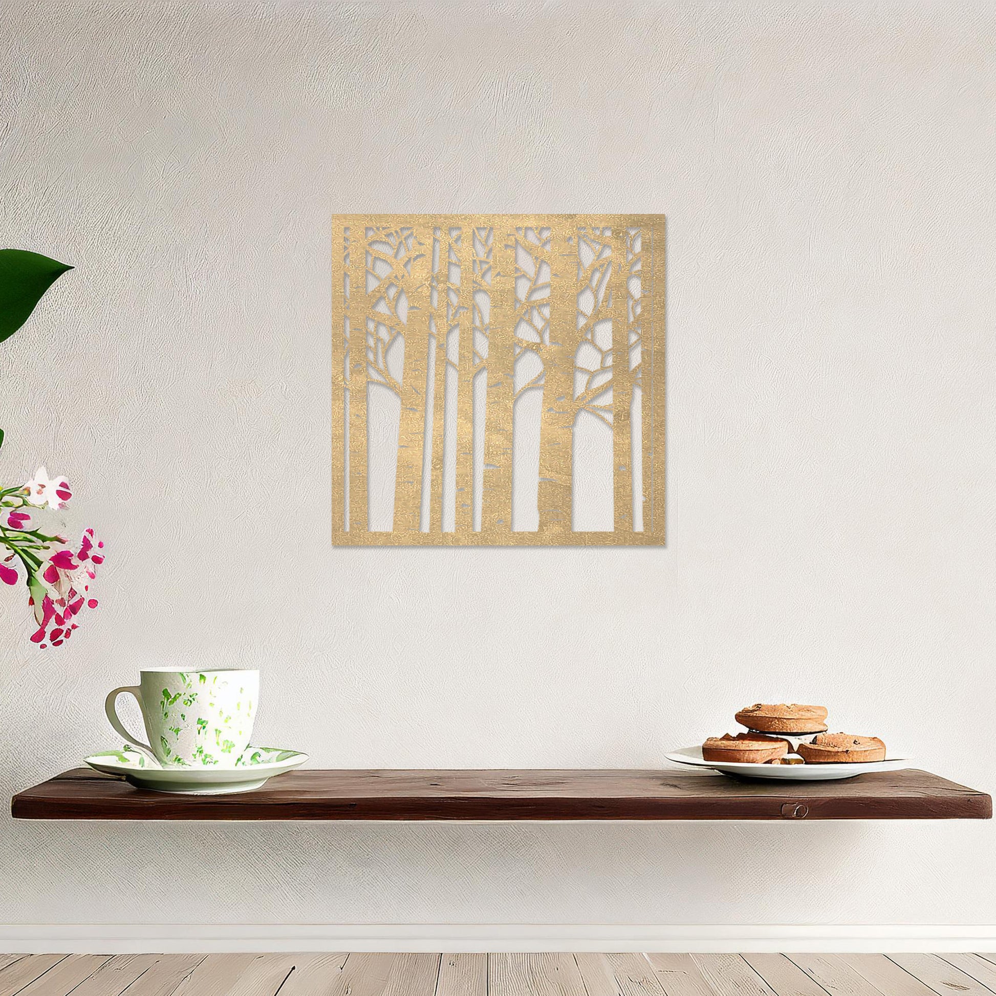Wooden wall art featuring a square design with a forest motif of tall, slender trees and intricate branch details. The artwork is displayed on a neutral wall within modern room decor, creating a serene and nature-inspired aesthetic.
