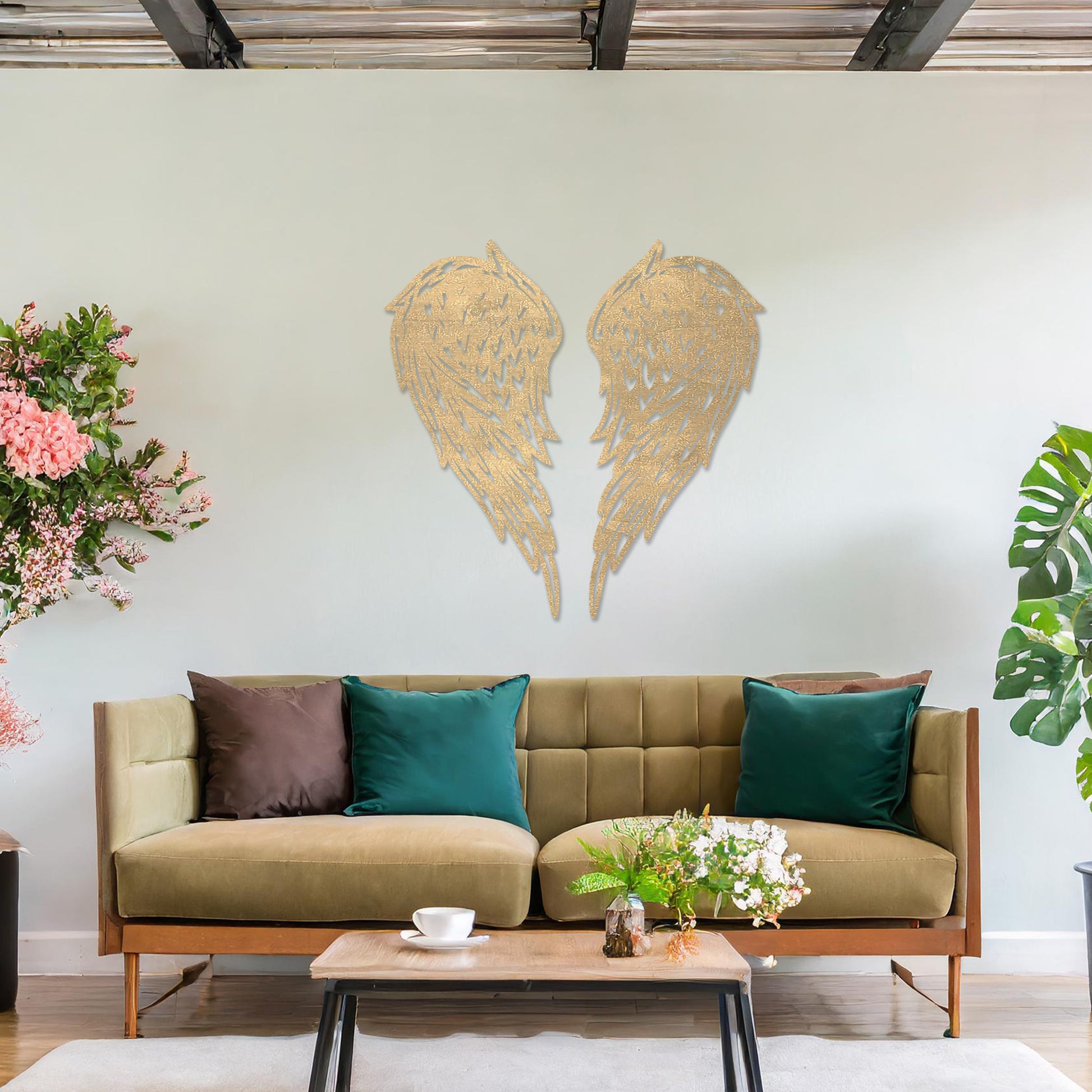Wall art showcasing intricately designed angel wings with detailed feather patterns, displayed on a neutral wall in a modern living room. The piece adds a sense of elegance and serenity to the contemporary decor.