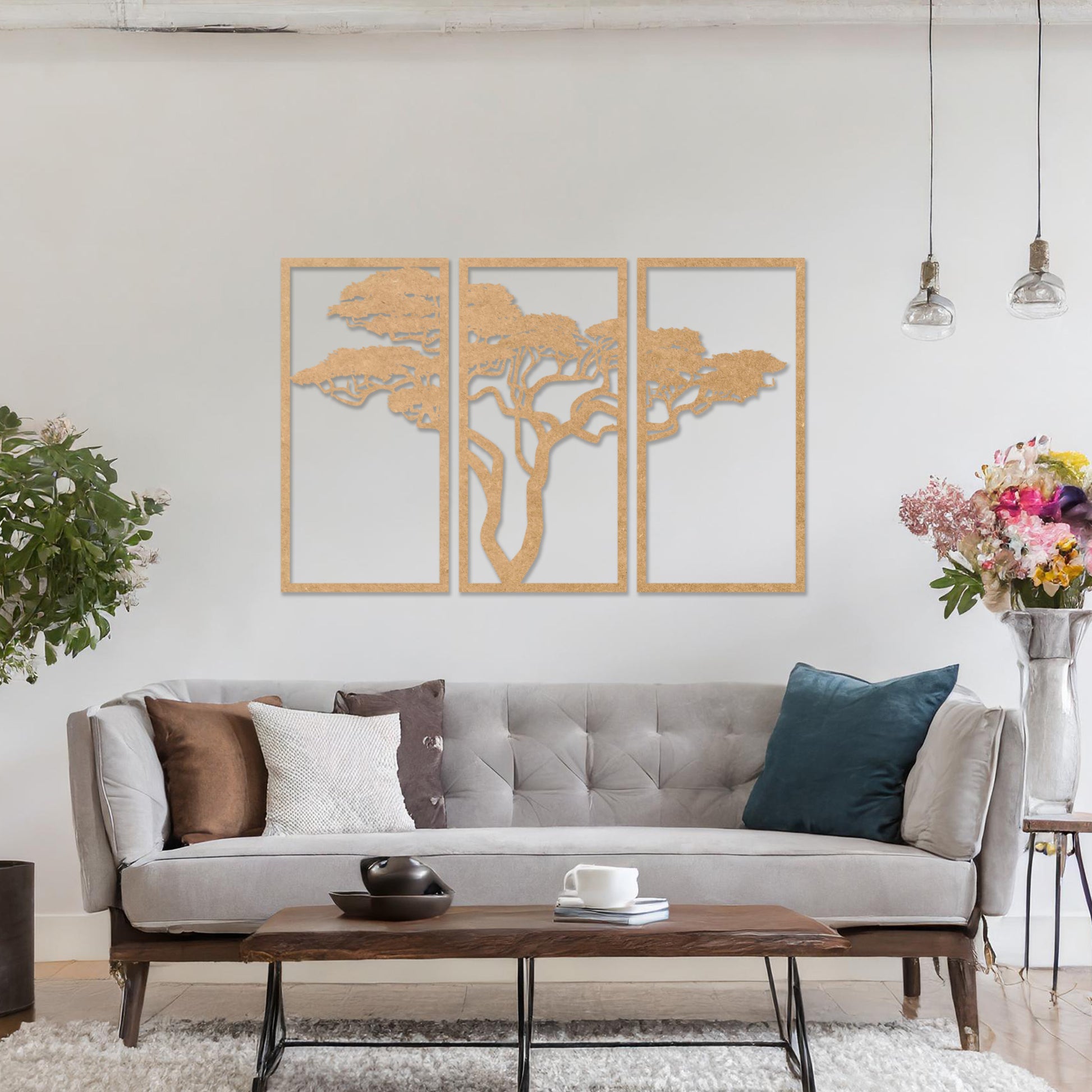 Three-panel wooden wall art featuring an elegant silhouette of a tree with spreading branches, displayed on a neutral wall within modern room decor. The intricate design adds depth and sophistication to the space.