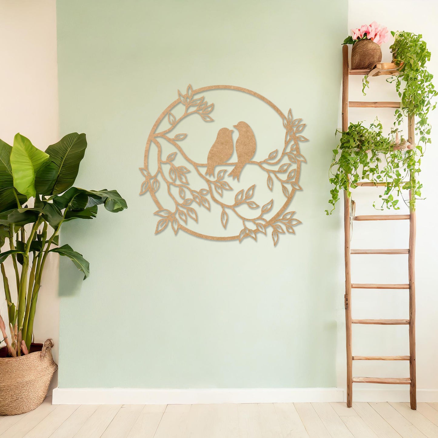 Wooden wall art featuring a circular design with two birds perched on a branch surrounded by leaves, displayed on a neutral wall within modern room decor, showcasing its delicate and nature-inspired craftsmanship.