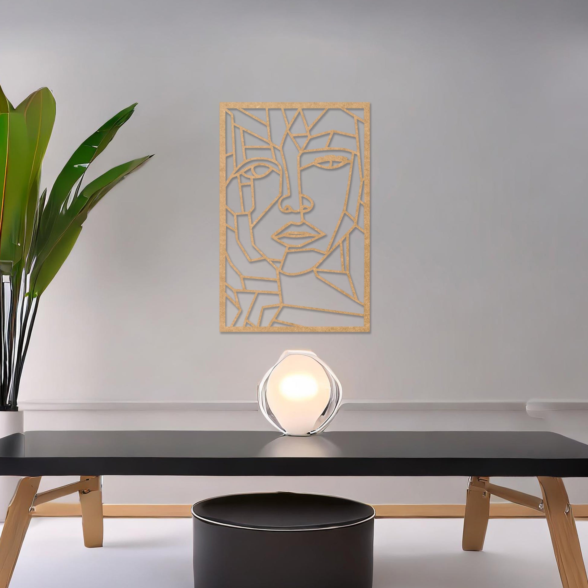 Wall art featuring a geometric abstract face design with sharp angular lines forming a modern and artistic composition. The piece is displayed on a neutral wall within contemporary decor, adding a bold and creative focal point to the space.