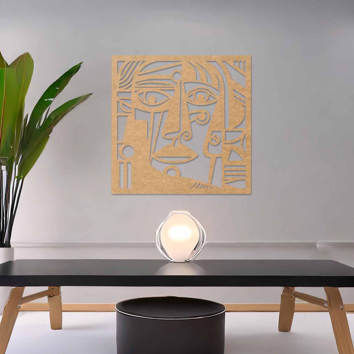 Wall art featuring an abstract face design with bold geometric shapes and intricate linework. The piece is displayed on a neutral wall within modern decor, adding an artistic and expressive focal point to the space.