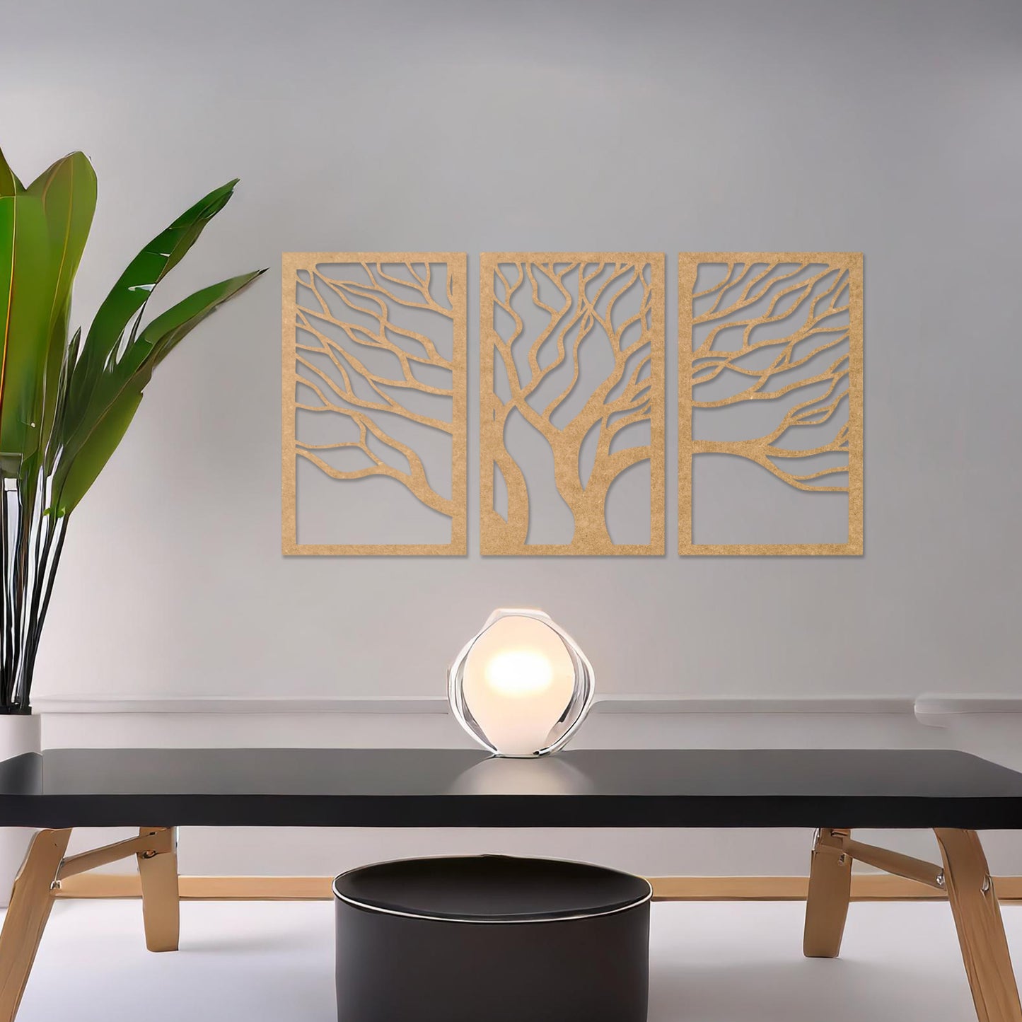A three-panel wall art featuring a minimalist tree design with flowing, intricate branches. The artwork is displayed on a neutral wall in a modern living room, complementing the contemporary decor and adding a touch of natural elegance.