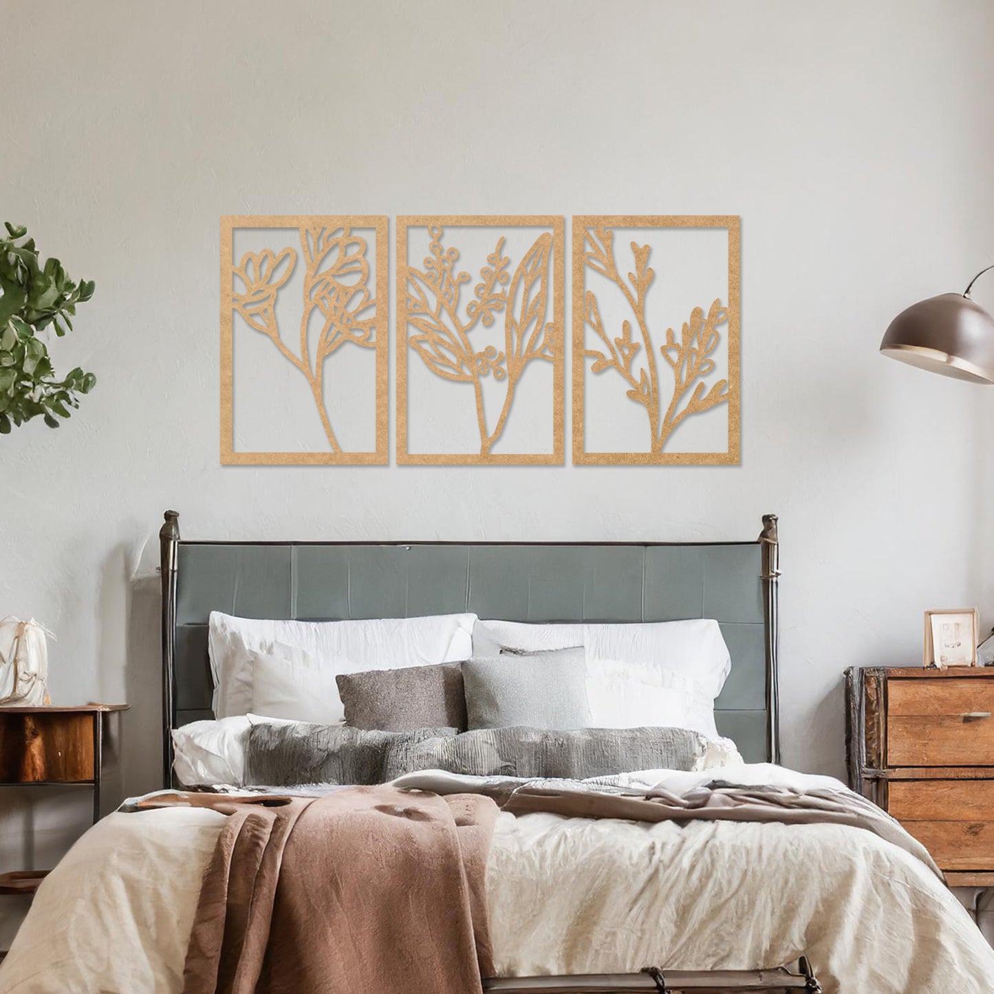 Wall art featuring a triptych of minimalist botanical designs, each panel highlighting delicate stems, leaves, and berries. The artwork is displayed on a neutral wall within modern decor, adding a subtle and natural elegance to the space.