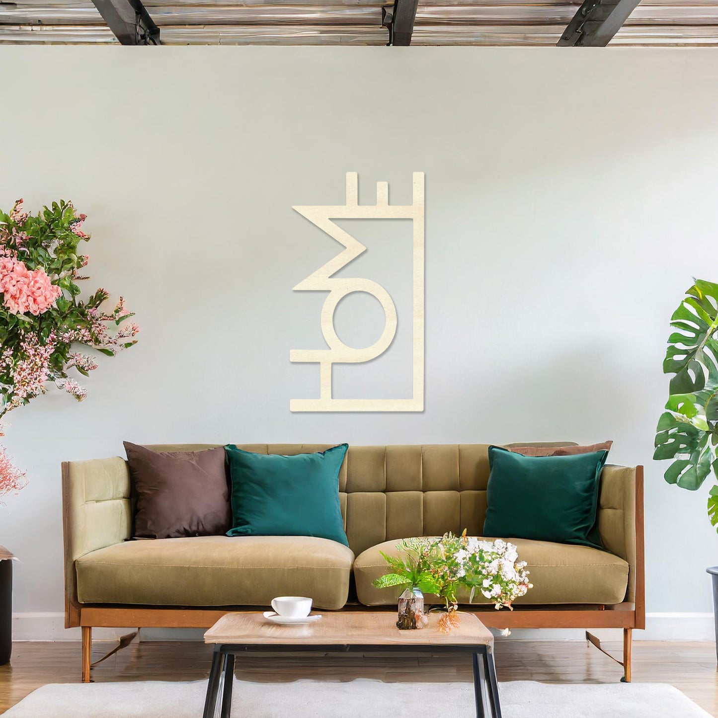 Wall art featuring the word "HOME" in a bold, modern design with geometric shapes integrated into the lettering. The piece is displayed on a neutral wall within contemporary room decor, adding a stylish and welcoming touch to the space.