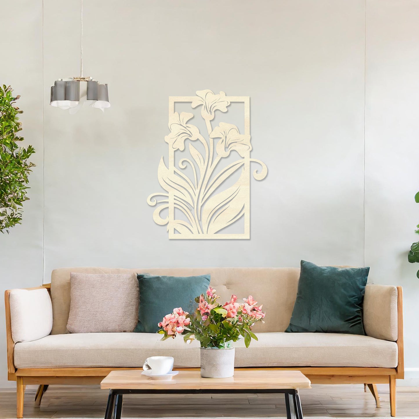 Wall art featuring an elegant floral design with three blooming lilies and flowing leaves enclosed in a rectangular frame. The piece is displayed on a neutral wall within modern room decor, adding a graceful and artistic touch to the setting.