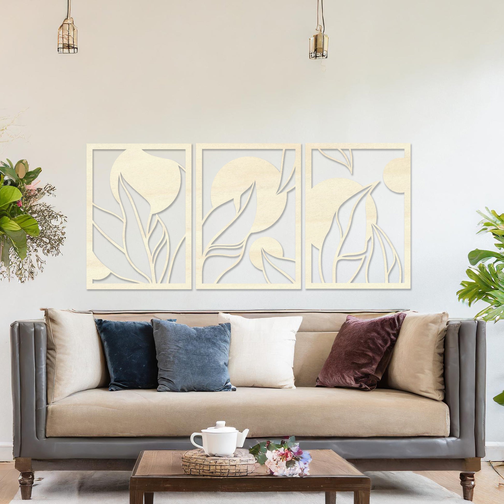 Wooden wall art design featuring a three-panel composition with abstract shapes and flowing leaves, placed on a neutral wall within modern room decor. The design blends geometric forms and natural elements for a contemporary aesthetic.