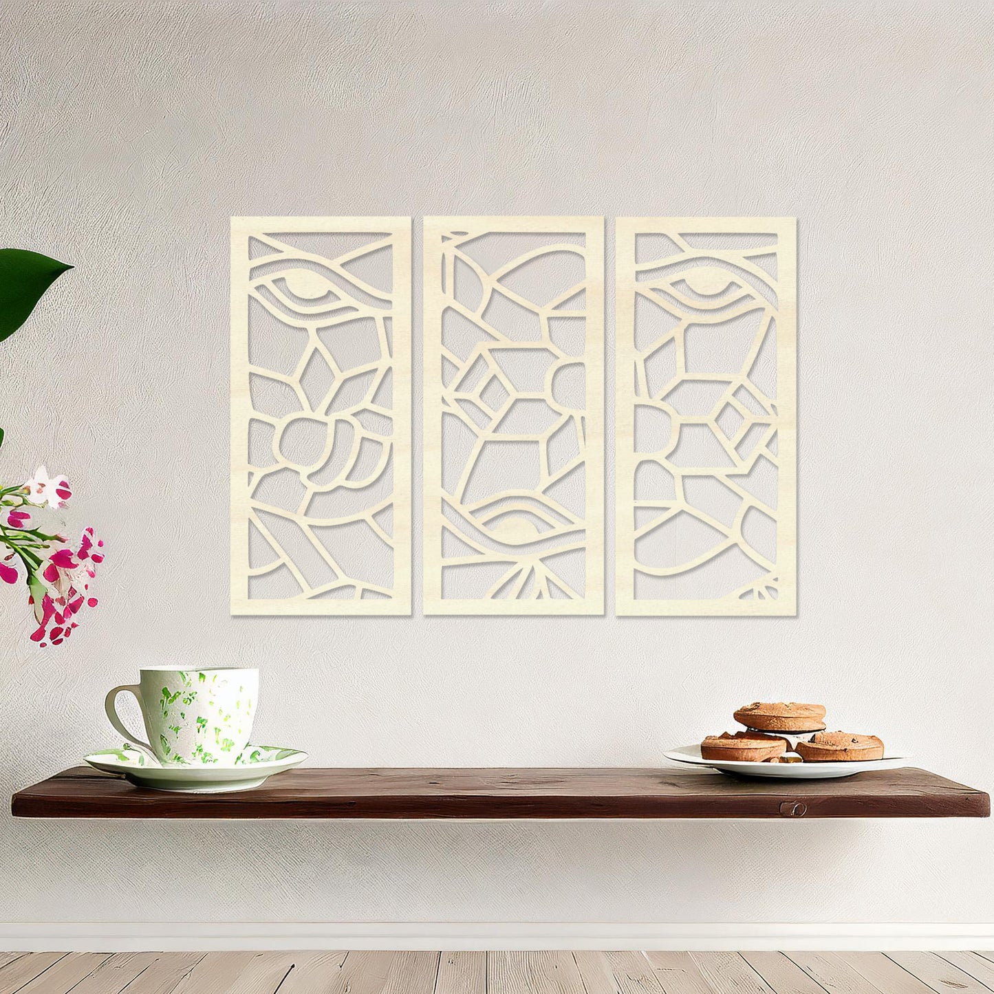 Wooden wall art featuring a three-panel abstract design with geometric shapes and eye motifs. The artwork is displayed on a neutral wall within modern room decor, showcasing its intricate and unique pattern.