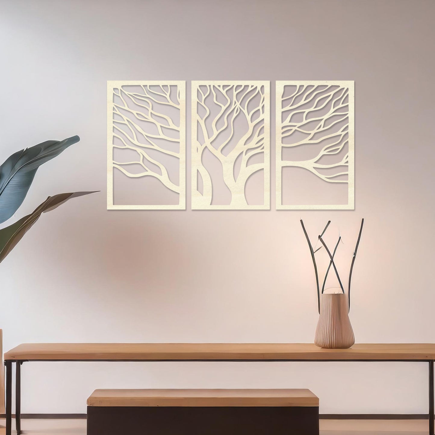 A three-panel wall art featuring a minimalist tree design with flowing, intricate branches. The artwork is displayed on a neutral wall in a modern living room, complementing the contemporary decor and adding a touch of natural elegance.
