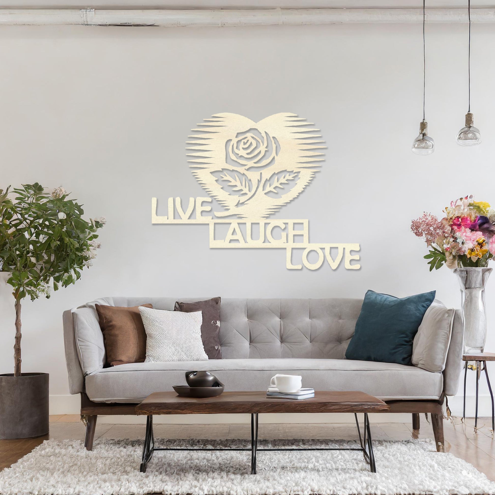 The design features the phrase "LIVE LAUGH LOVE" arranged in a staggered layout, with a rose inside a heart shape above the text. The clean, geometric lines of the text and the heart-shaped rose create a striking, modern look.