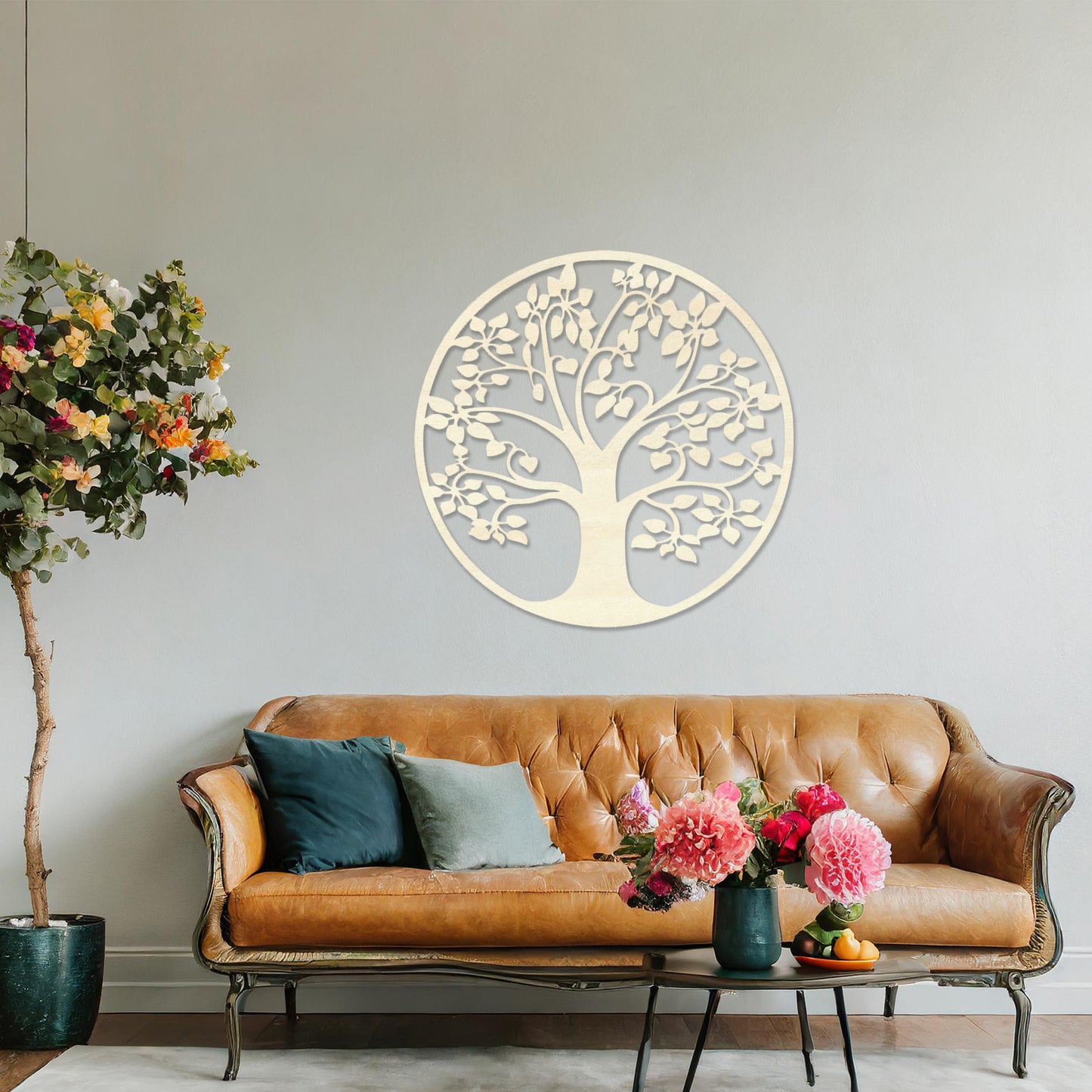 Wooden wall art featuring a circular tree design with detailed leaves and branches, displayed on a neutral wall within modern room decor, emphasising its natural elegance and intricate craftsmanship.