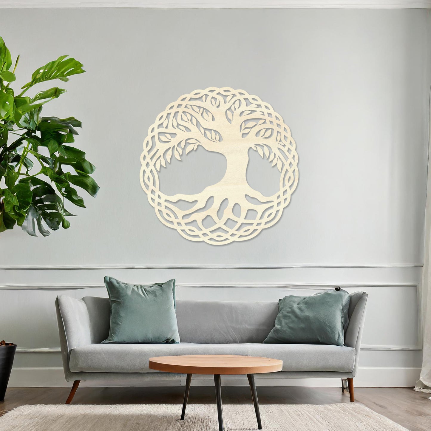 Wooden wall art featuring a circular tree of life design with intertwined roots and branches, displayed on a neutral wall within modern room decor, highlighting its symbolic and intricate craftsmanship.