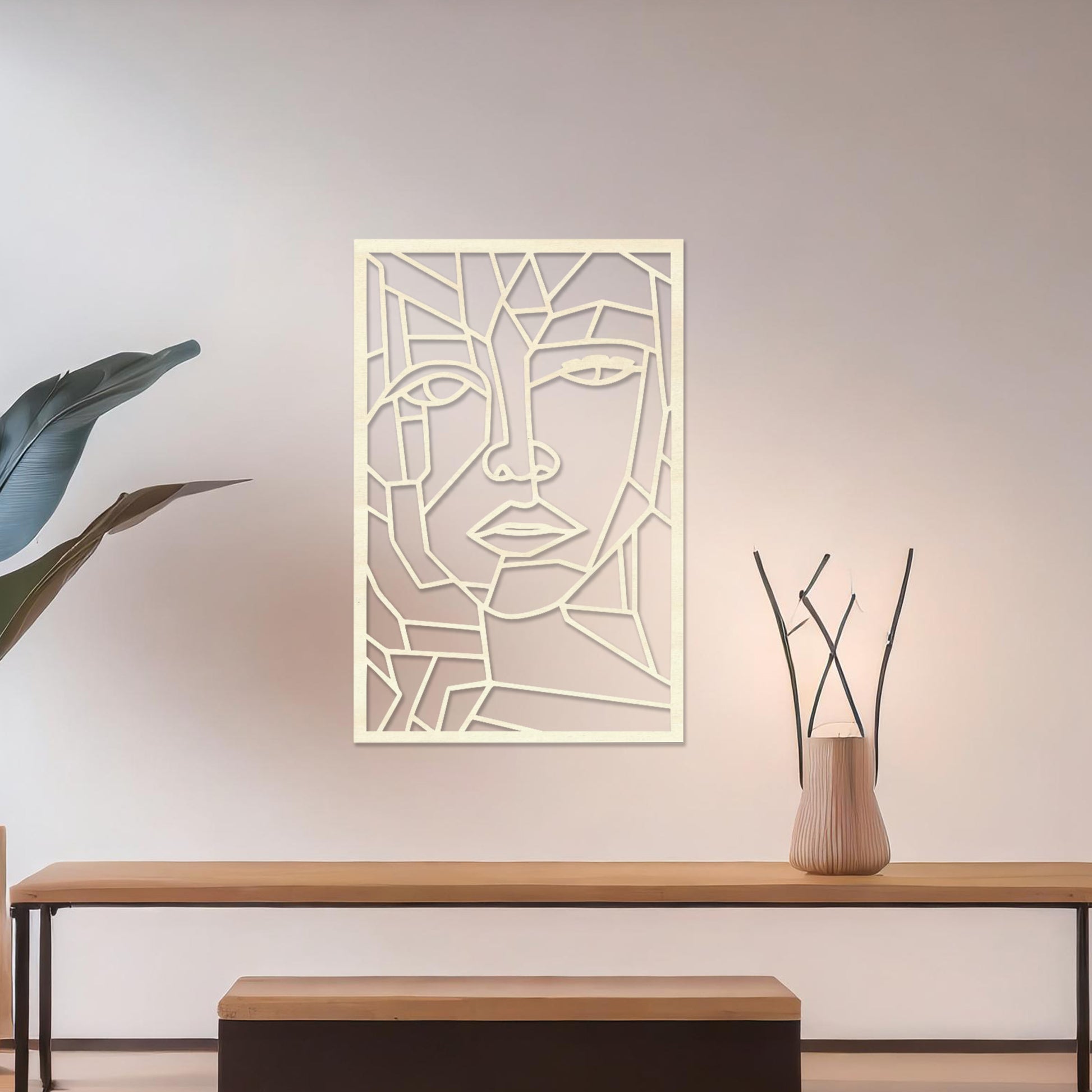 Wall art featuring a geometric abstract face design with sharp angular lines forming a modern and artistic composition. The piece is displayed on a neutral wall within contemporary decor, adding a bold and creative focal point to the space.