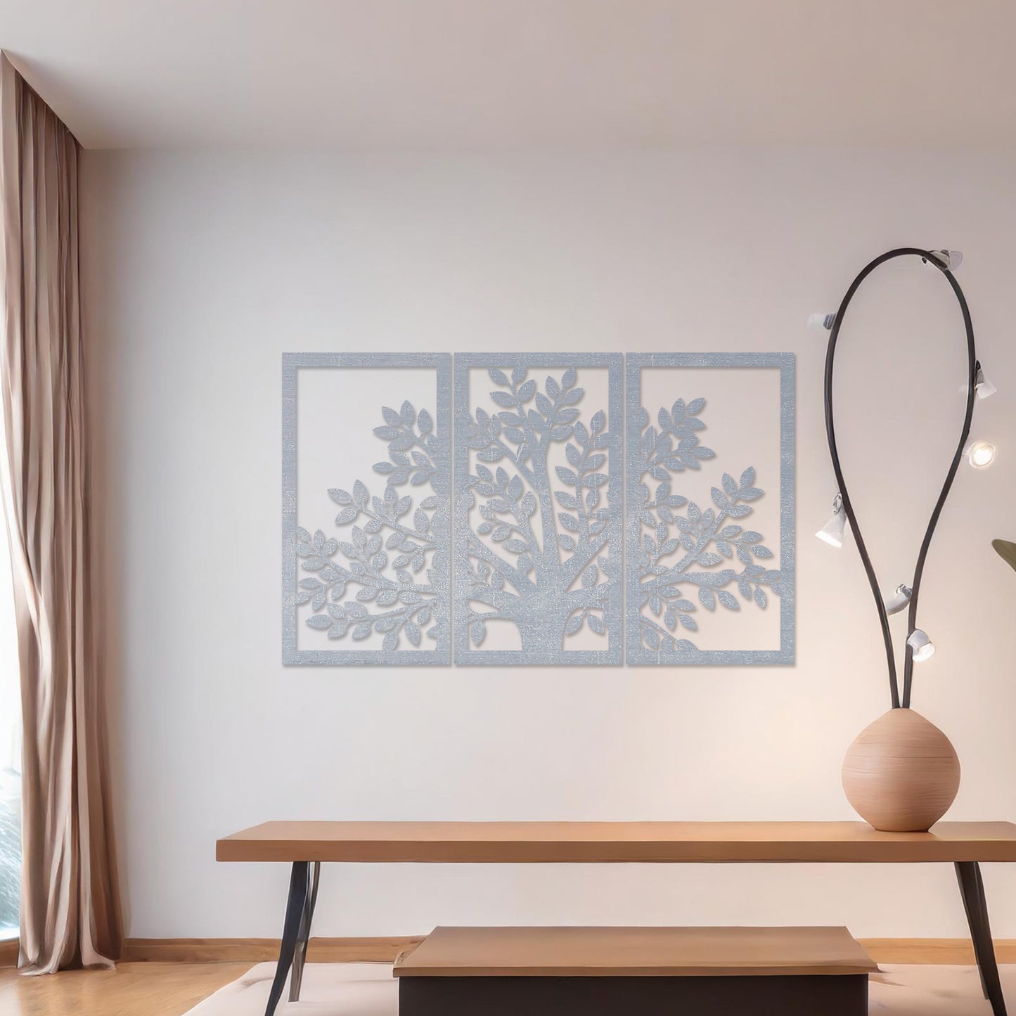 Wooden wall art comprising three panels featuring a tree design with detailed leaves and branches, displayed on a neutral wall within modern room decor, showcasing its intricate and natural craftsmanship.