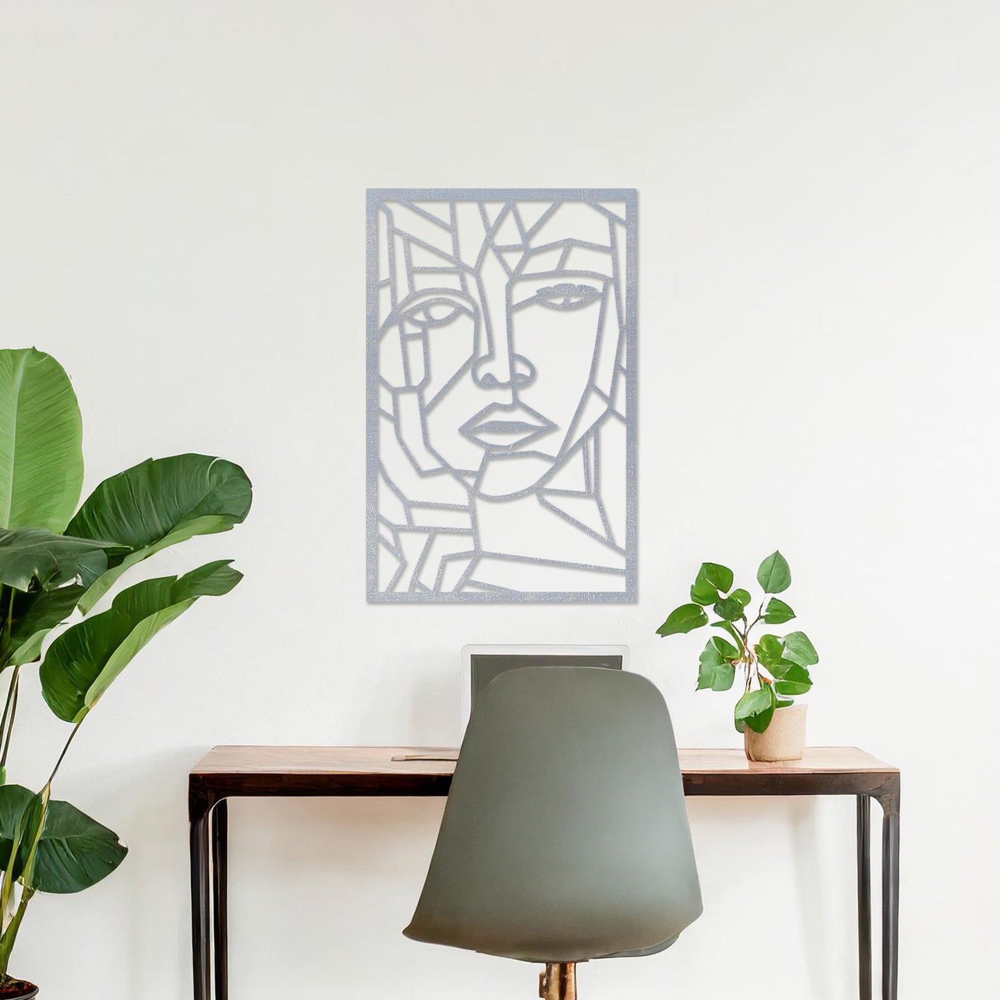Wall art featuring a geometric abstract face design with sharp angular lines forming a modern and artistic composition. The piece is displayed on a neutral wall within contemporary decor, adding a bold and creative focal point to the space.