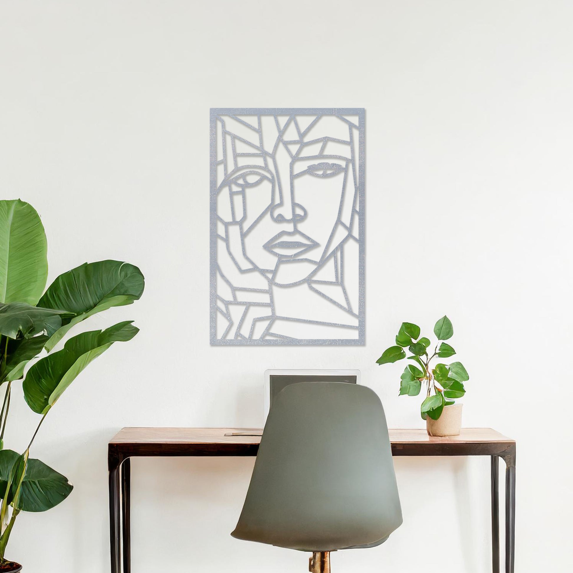 Wall art featuring a geometric abstract face design with sharp angular lines forming a modern and artistic composition. The piece is displayed on a neutral wall within contemporary decor, adding a bold and creative focal point to the space.