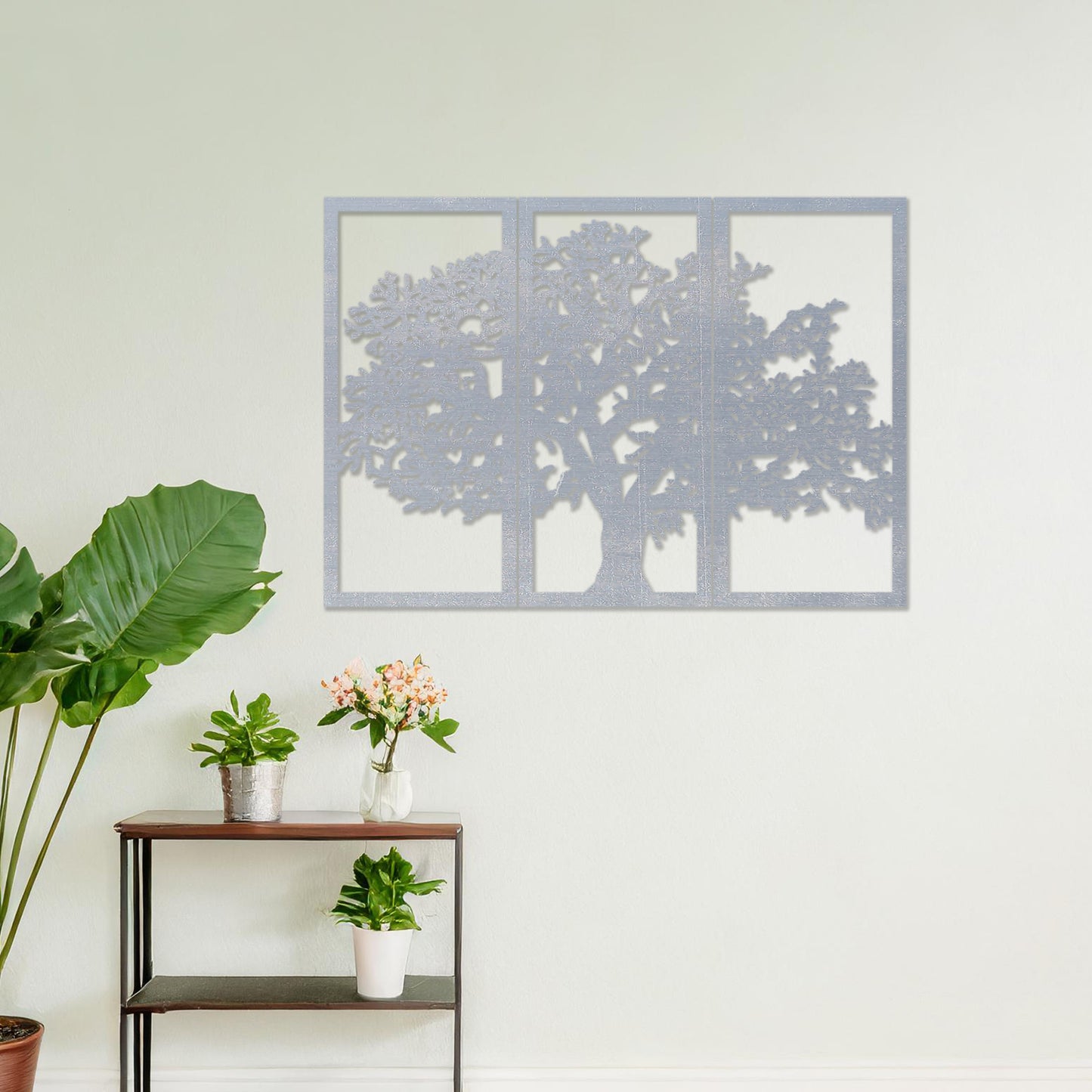 Wooden wall art in three panels depicting a detailed tree design with intricate branches, set on a neutral wall within modern room decor, highlighting its natural and artistic aesthetic.