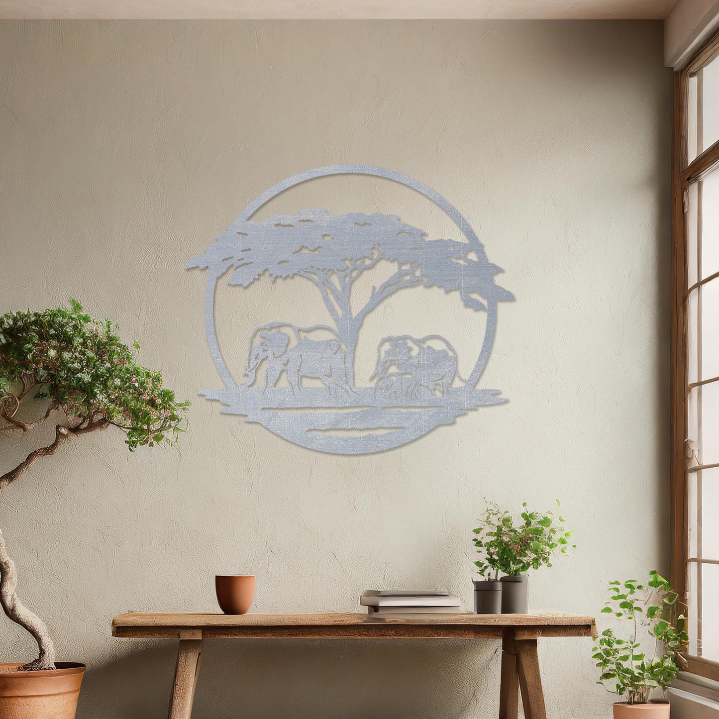 Wooden wall art design featuring two elephants under a tree, framed in a circular shape, placed on a neutral wall within modern room decor. The design evokes a sense of tranquility and nature with its detailed depiction of wildlife.