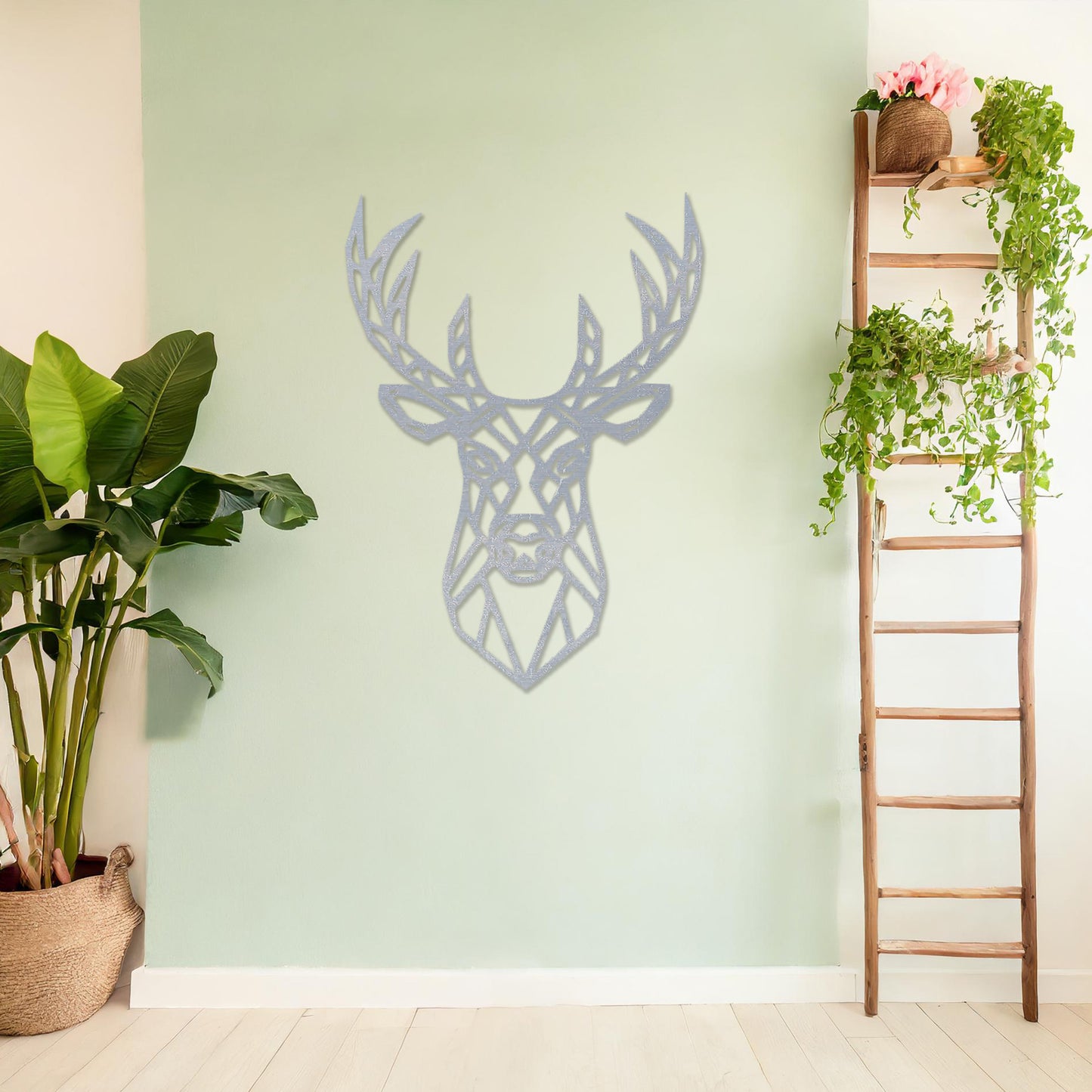 Wooden wall art featuring a geometric deer head design with intricate antlers, displayed on a neutral wall within modern room decor, showcasing its bold and contemporary artistic style.