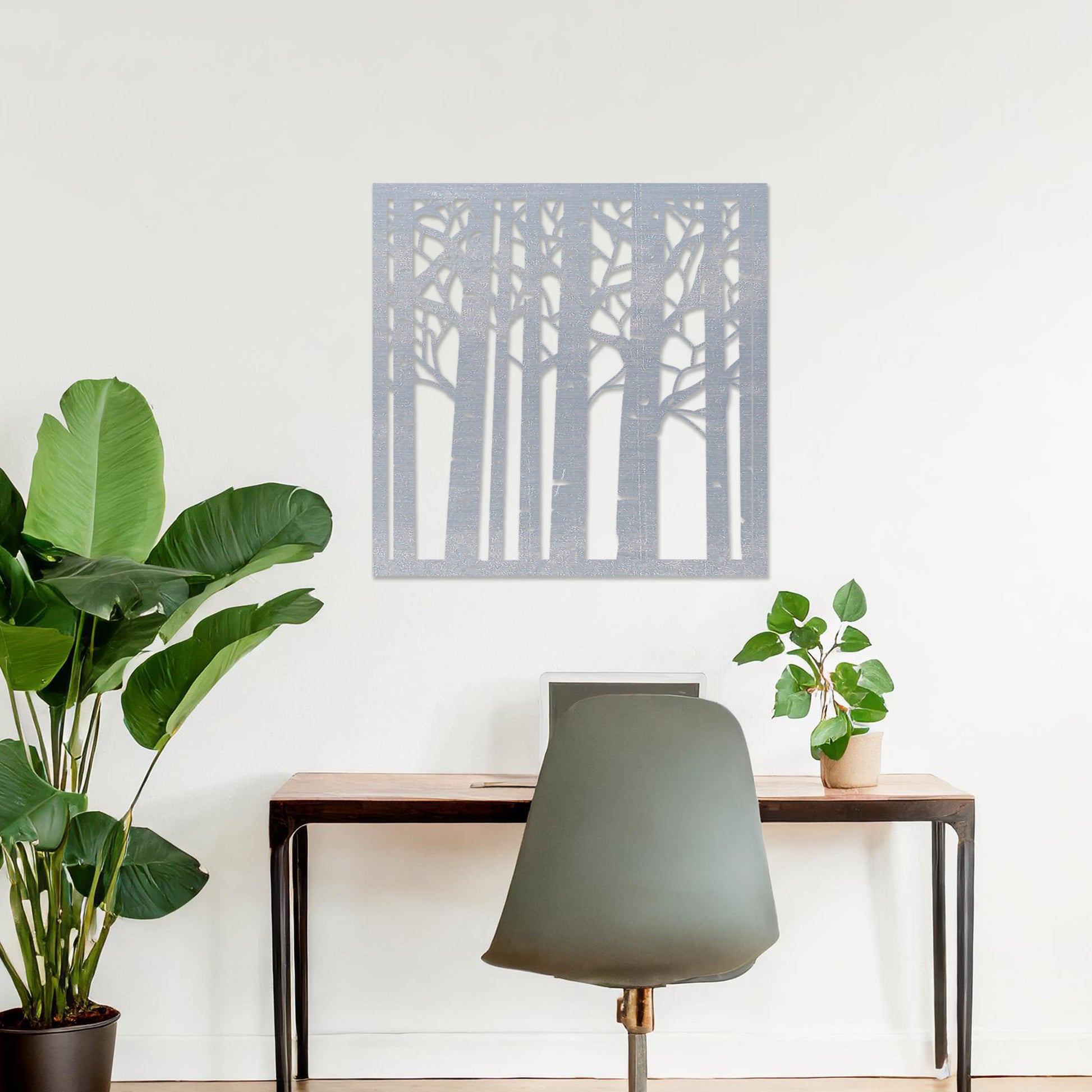 Wooden wall art featuring a square design with a forest motif of tall, slender trees and intricate branch details. The artwork is displayed on a neutral wall within modern room decor, creating a serene and nature-inspired aesthetic.