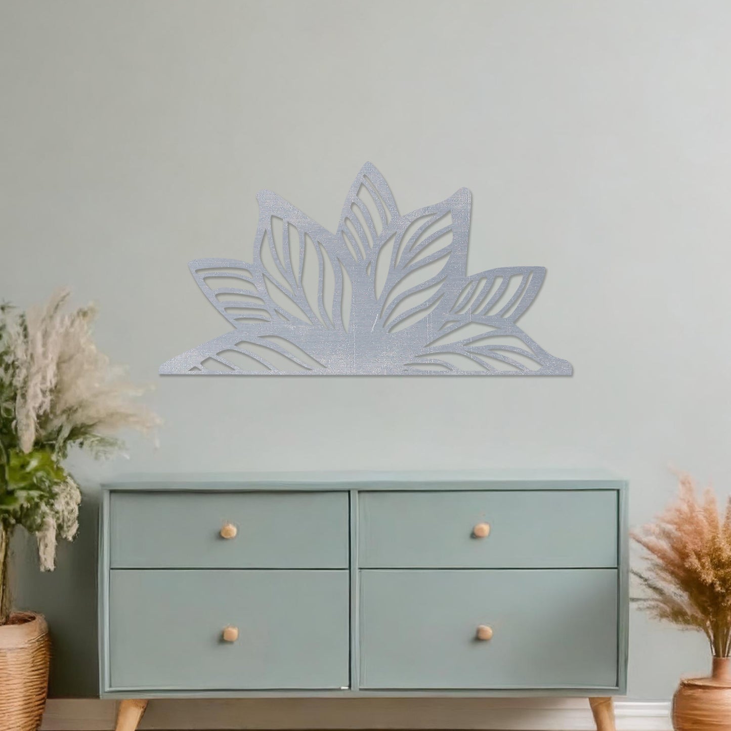 Wall art featuring a lotus-inspired design with layered leaves and intricate cut-out patterns. The piece is displayed on a neutral wall within modern decor, adding a natural and calming focal point to the space.
