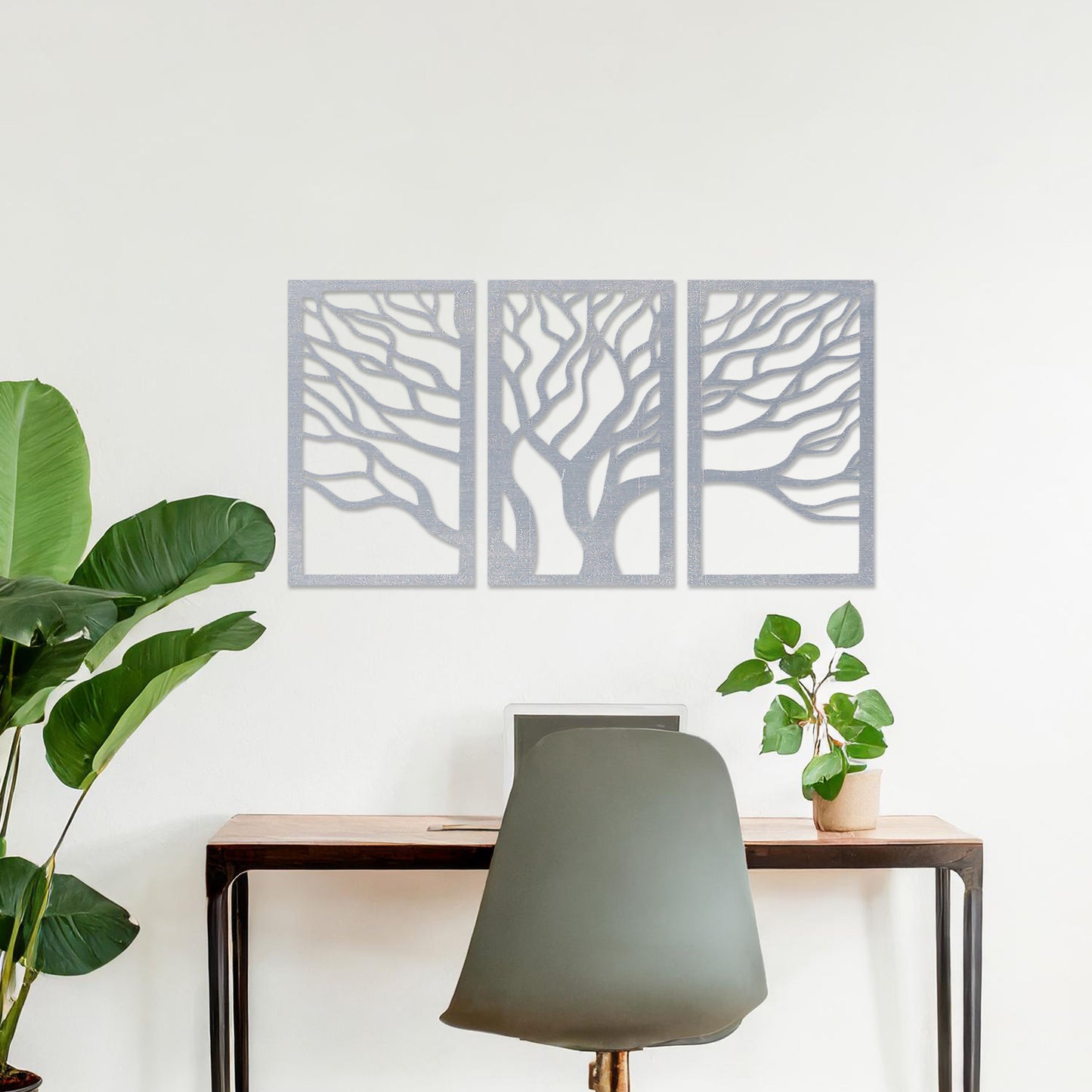A three-panel wall art featuring a minimalist tree design with flowing, intricate branches. The artwork is displayed on a neutral wall in a modern living room, complementing the contemporary decor and adding a touch of natural elegance.