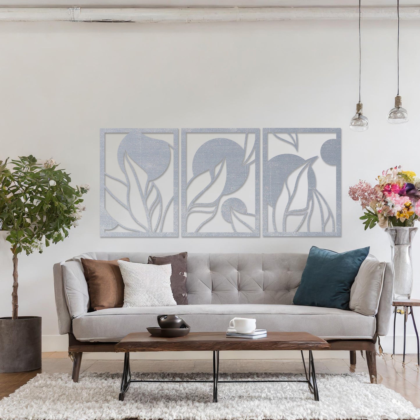 Wooden wall art design featuring a three-panel composition with abstract shapes and flowing leaves, placed on a neutral wall within modern room decor. The design blends geometric forms and natural elements for a contemporary aesthetic.
