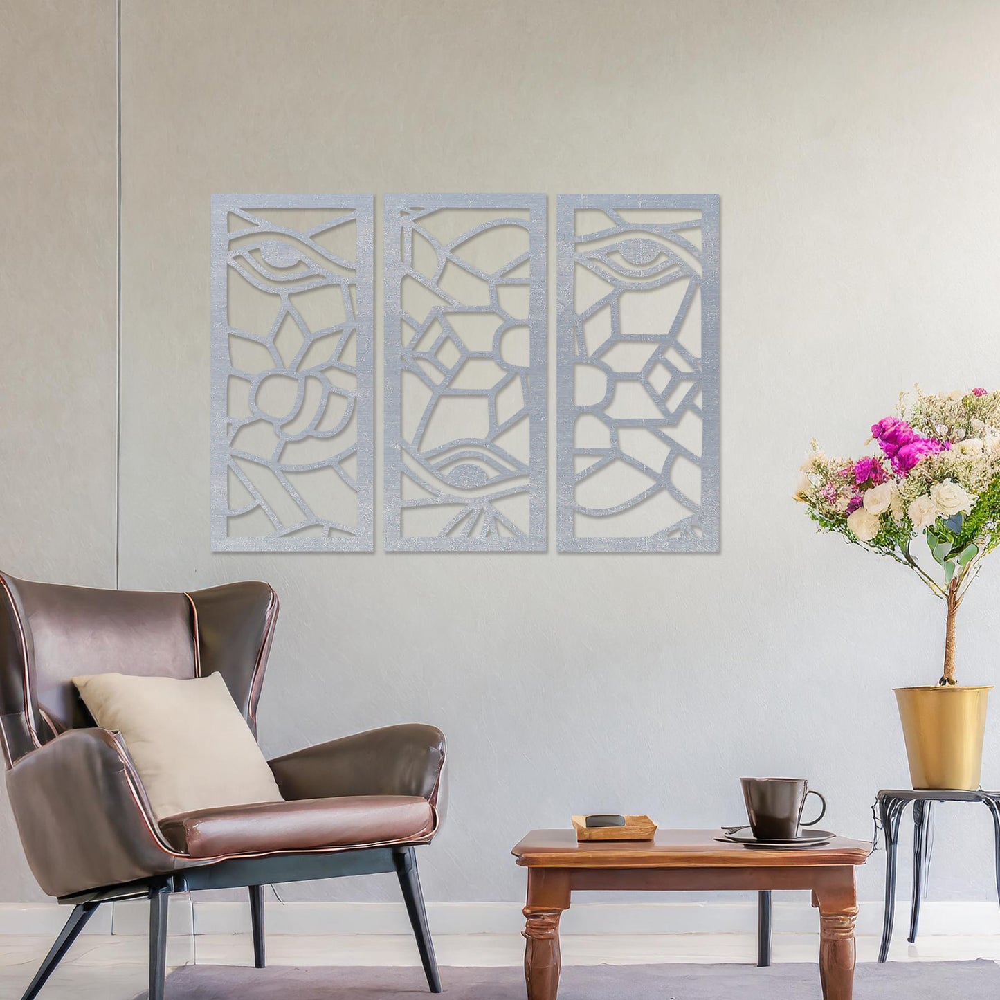 Wooden wall art featuring a three-panel abstract design with geometric shapes and eye motifs. The artwork is displayed on a neutral wall within modern room decor, showcasing its intricate and unique pattern.