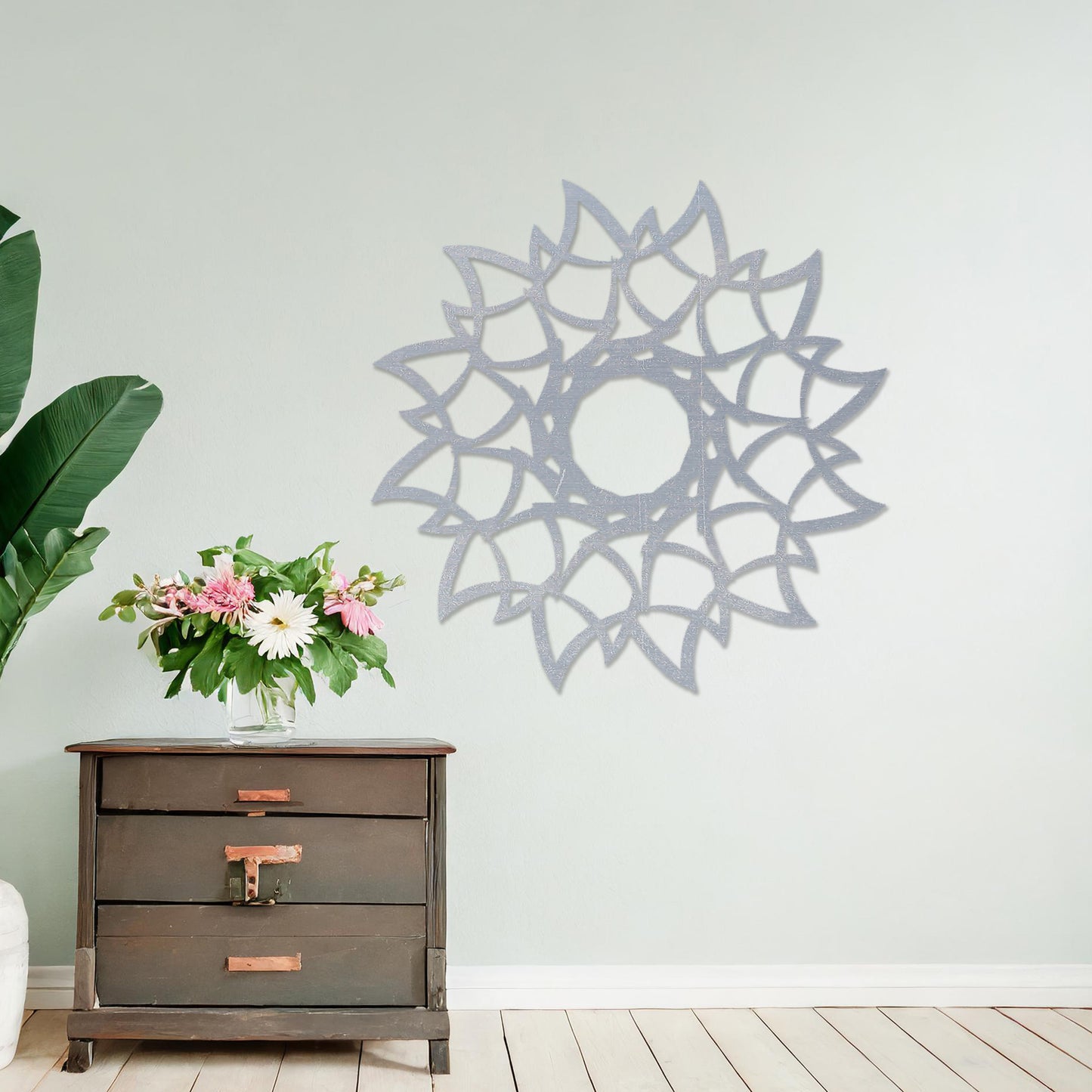Wooden wall art featuring a circular mandala-inspired design with intricate petal-like patterns, displayed on a neutral wall within modern room decor, showcasing its elegant and detailed craftsmanship.