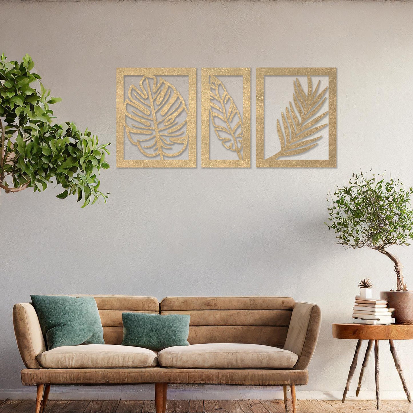 Wooden wall art set featuring three framed botanical designs with detailed leaf patterns, including monstera and palm leaves. The artwork is displayed on a neutral wall within modern room decor, adding a natural and elegant touch.