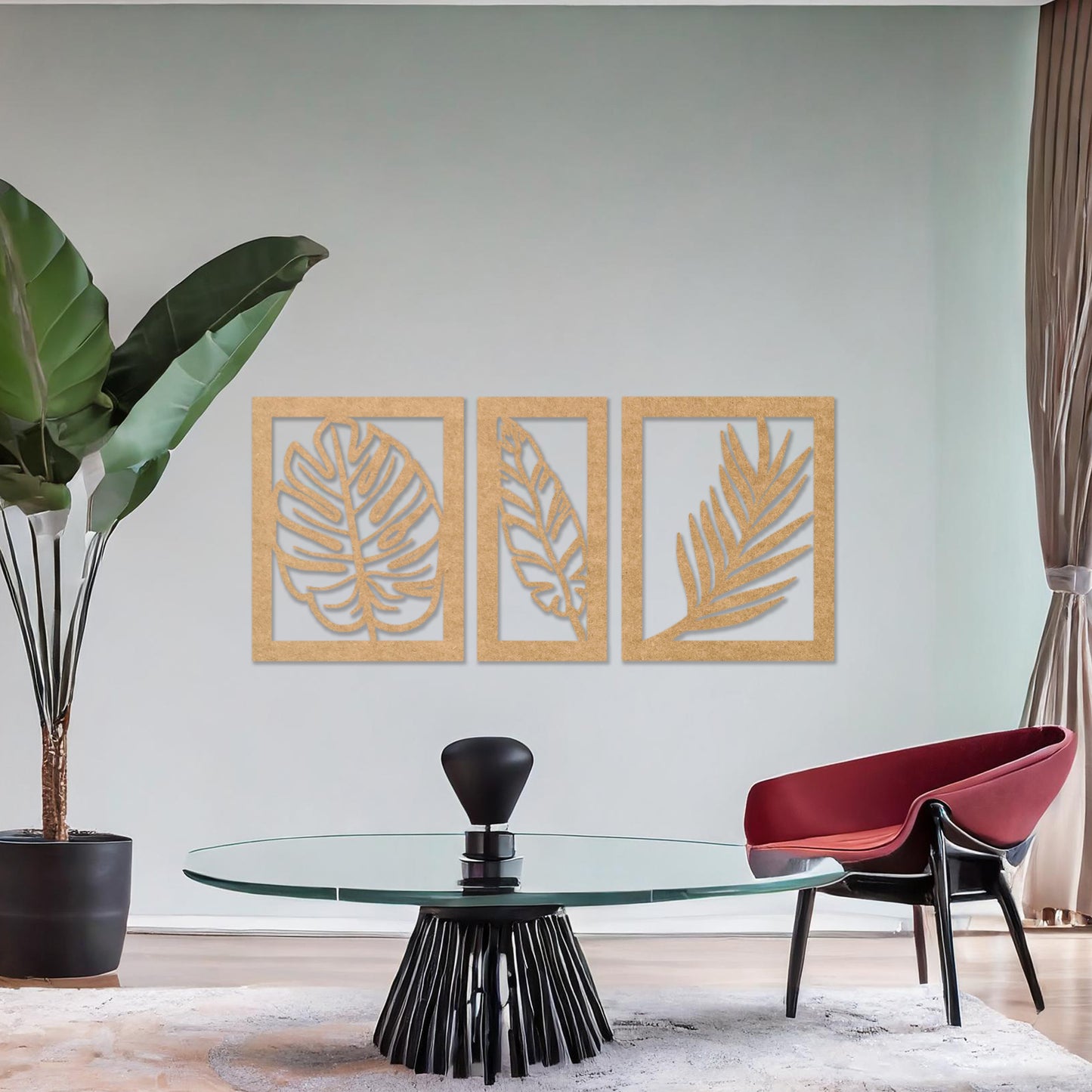 Wooden wall art set featuring three framed botanical designs with detailed leaf patterns, including monstera and palm leaves. The artwork is displayed on a neutral wall within modern room decor, adding a natural and elegant touch.