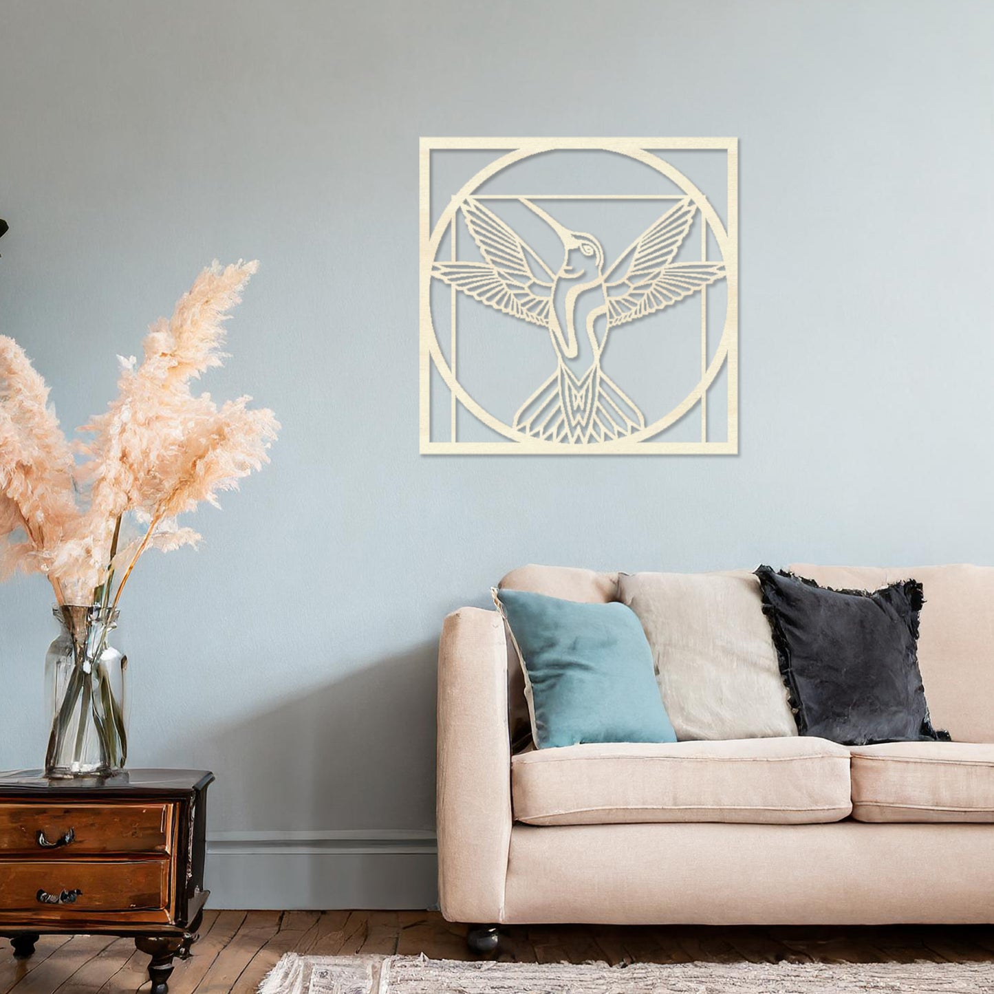Wooden hummingbird wall art showcasing a detailed design with outstretched wings in a geometric frame, placed on a neutral wall within modern room decor, adding a touch of elegance and nature-inspired artistry to the space.