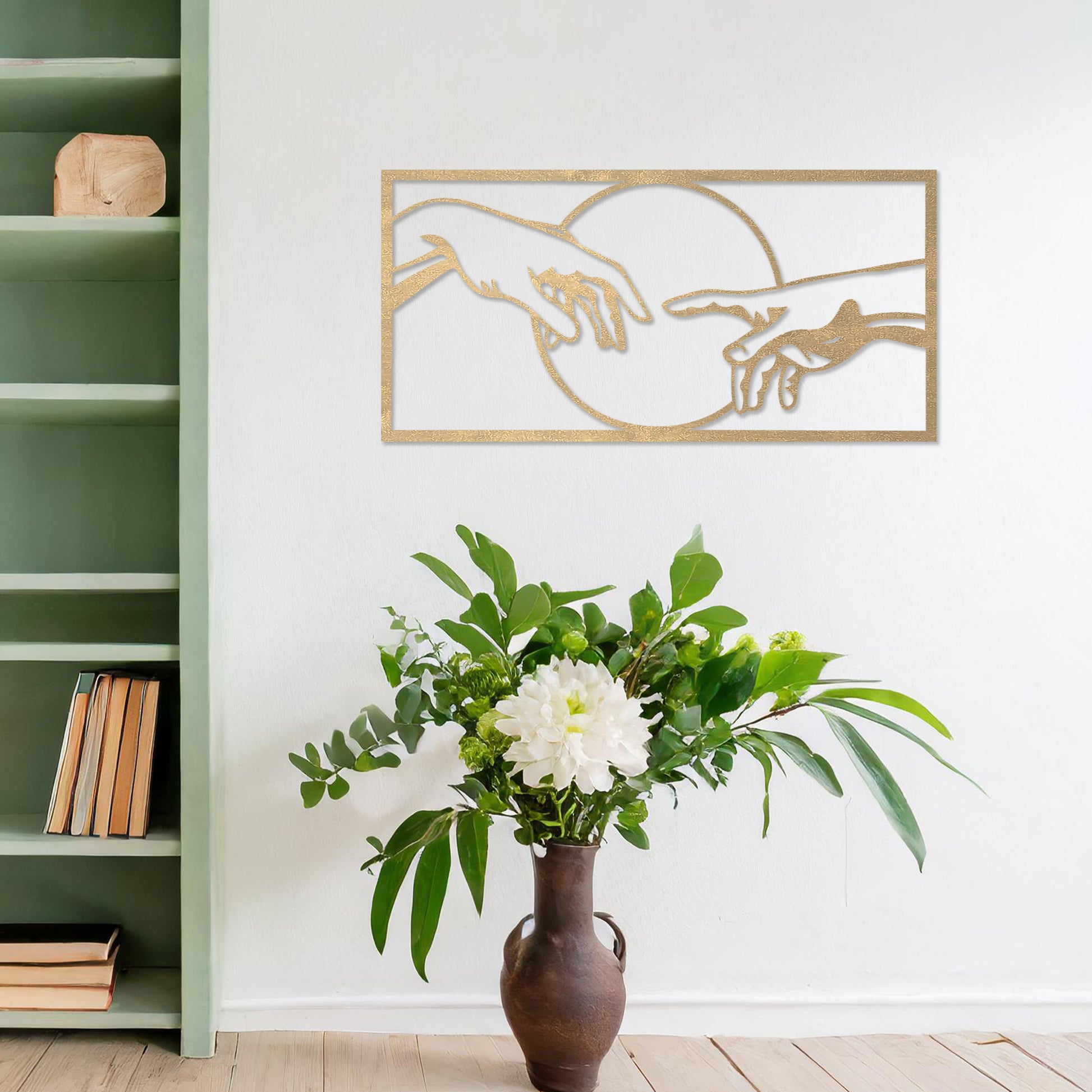 Wooden wall art featuring a minimalist depiction of two hands reaching out towards each other, framed by a circular design. Mounted on a neutral wall within modern room decor, this piece adds an artistic and meaningful touch to any space.