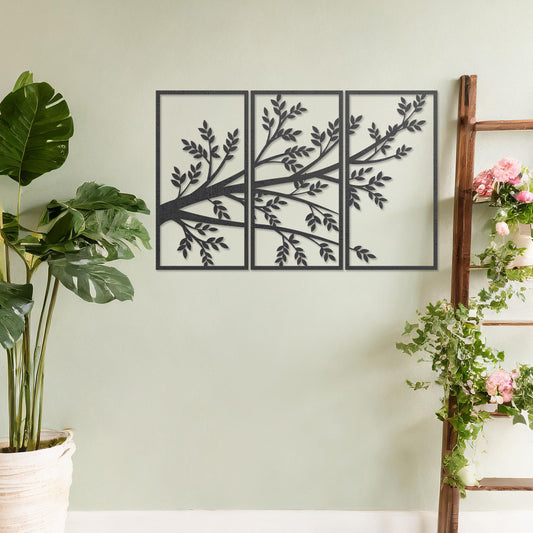 Wooden wall art featuring a three-panel design of a branching tree with delicate leaves extending gracefully across each panel. Mounted on a neutral wall within modern decor, this piece evokes a sense of natural elegance and harmony.